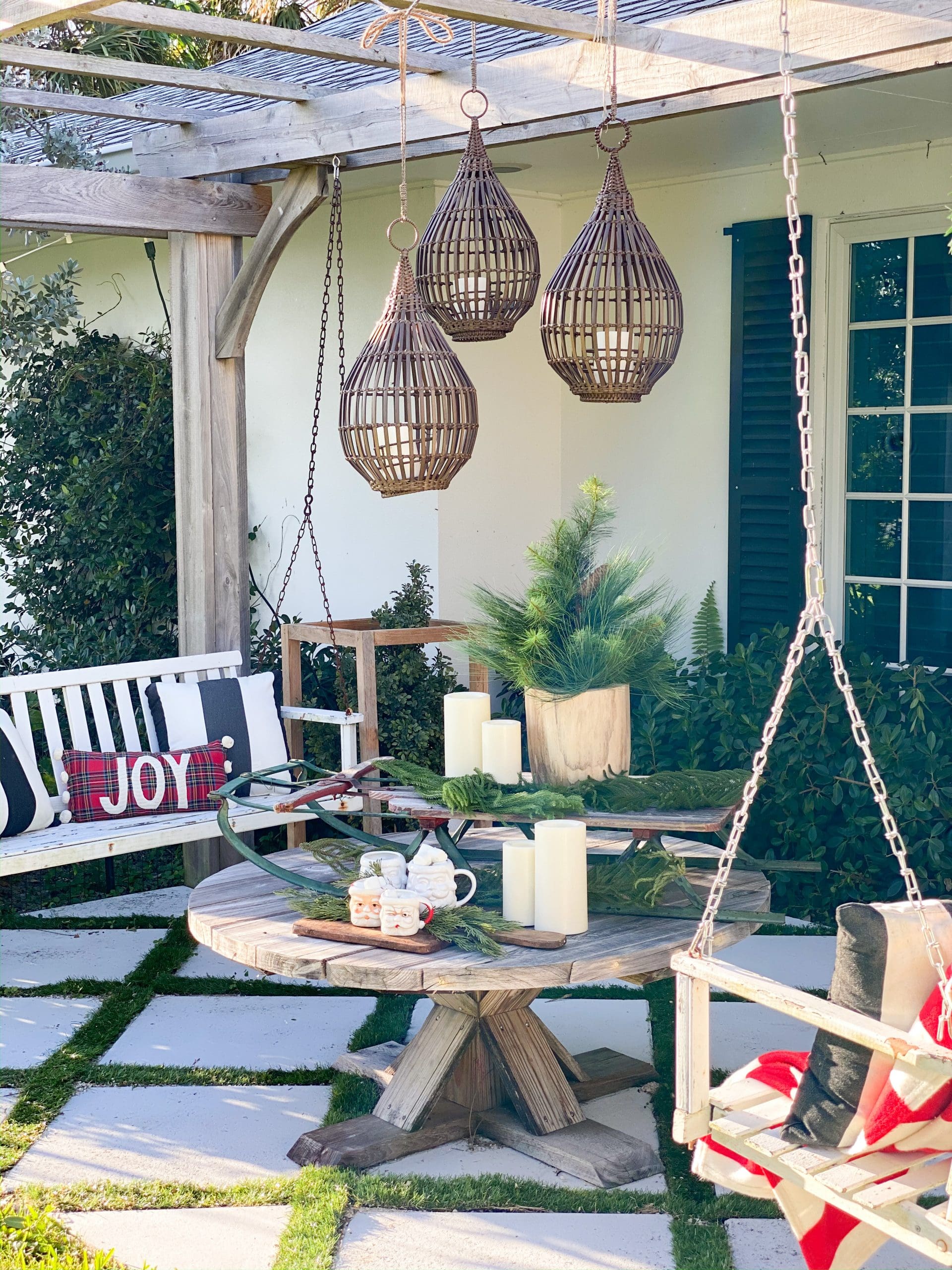 outdoor sitting space with porch swings styled with Christmas decor