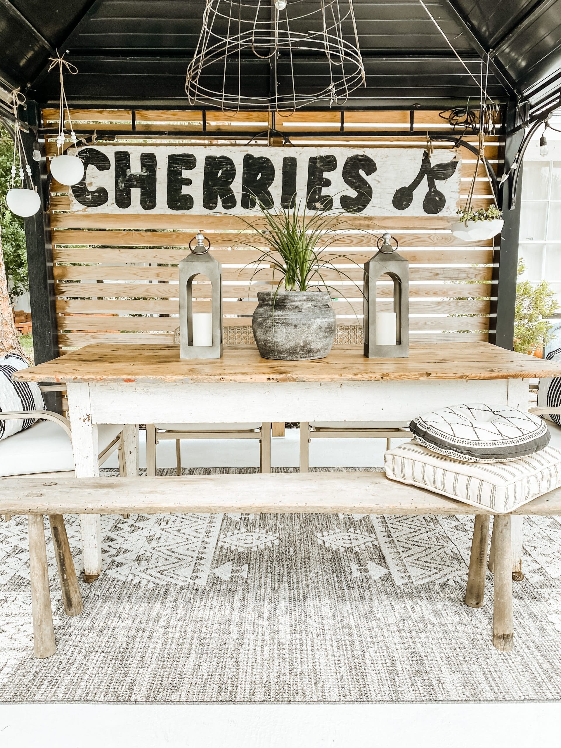 A rustic outdoor dining setup featuring multiple dishes and