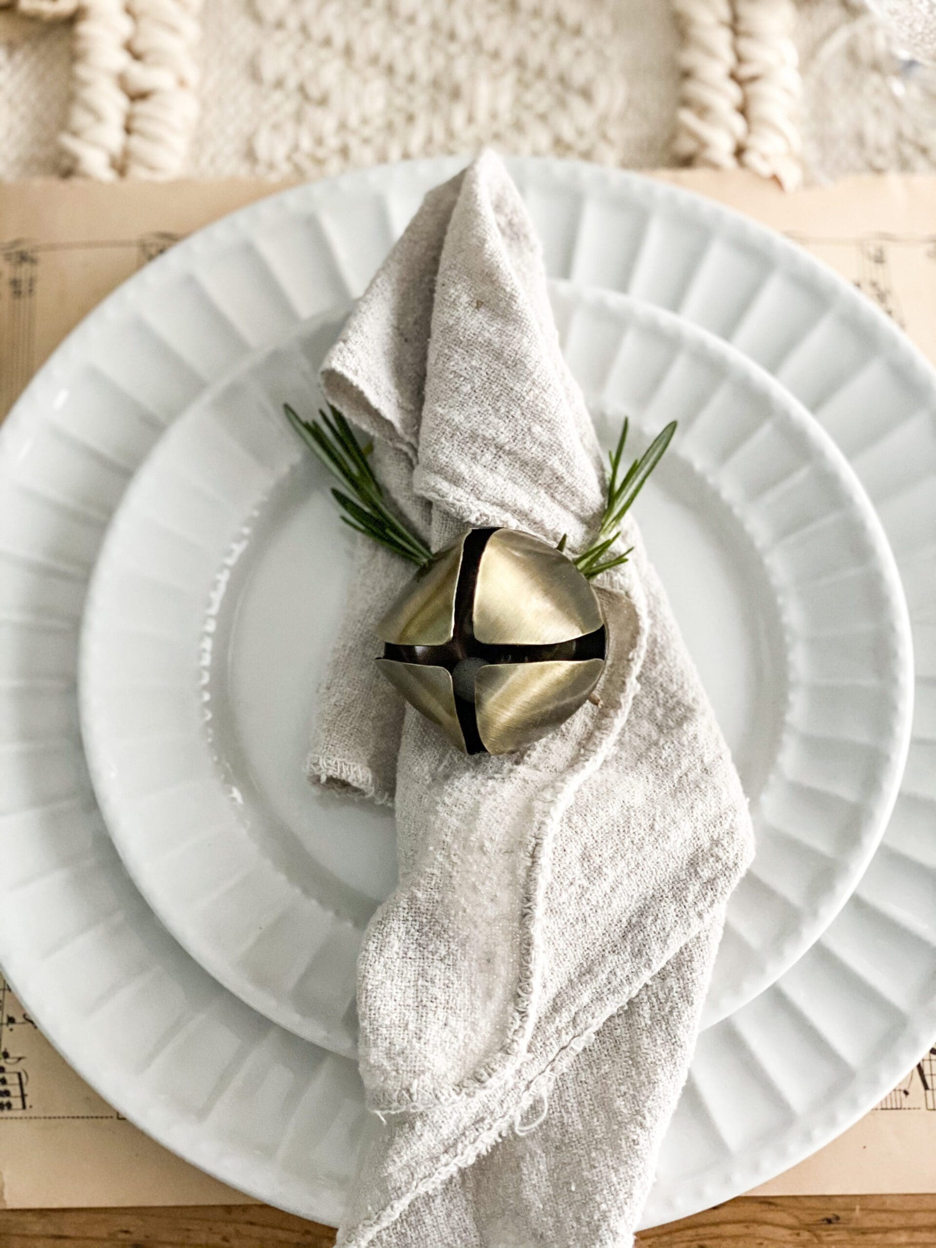 bell and small sprig tied to a napkin as a napkin ring