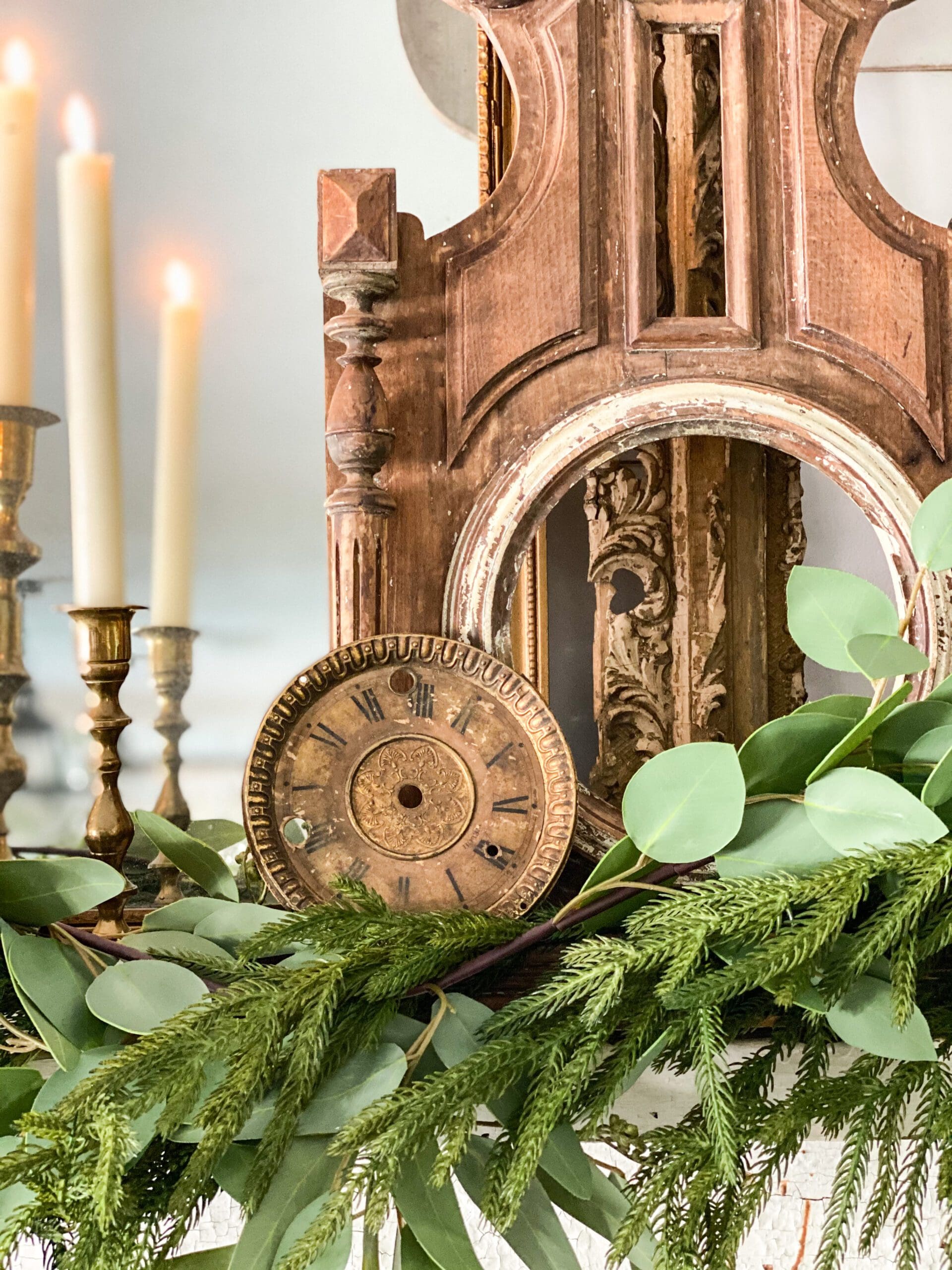 closeup of a small wooden clock on a white mantel