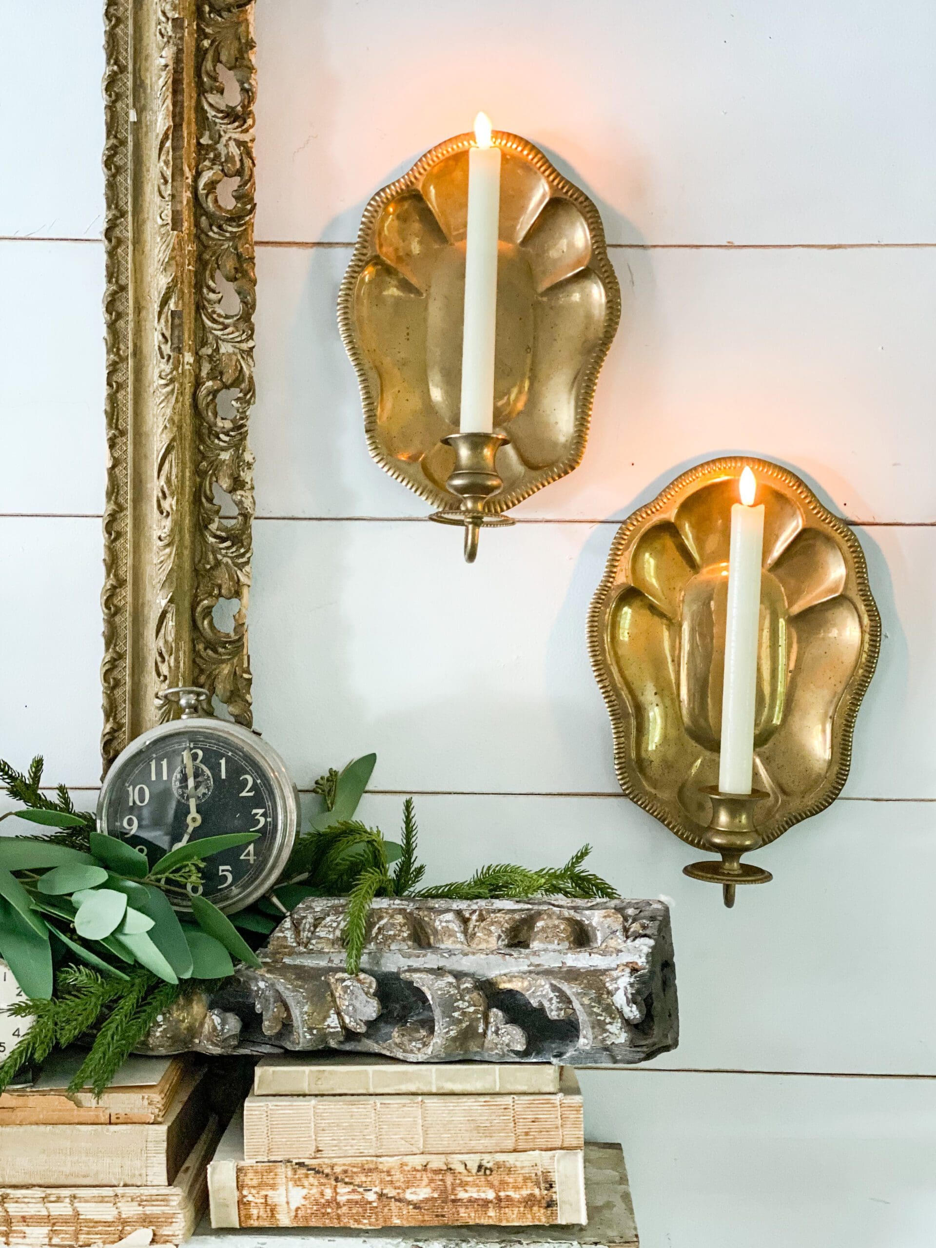 closeup of gold candle holders hanging on a wall