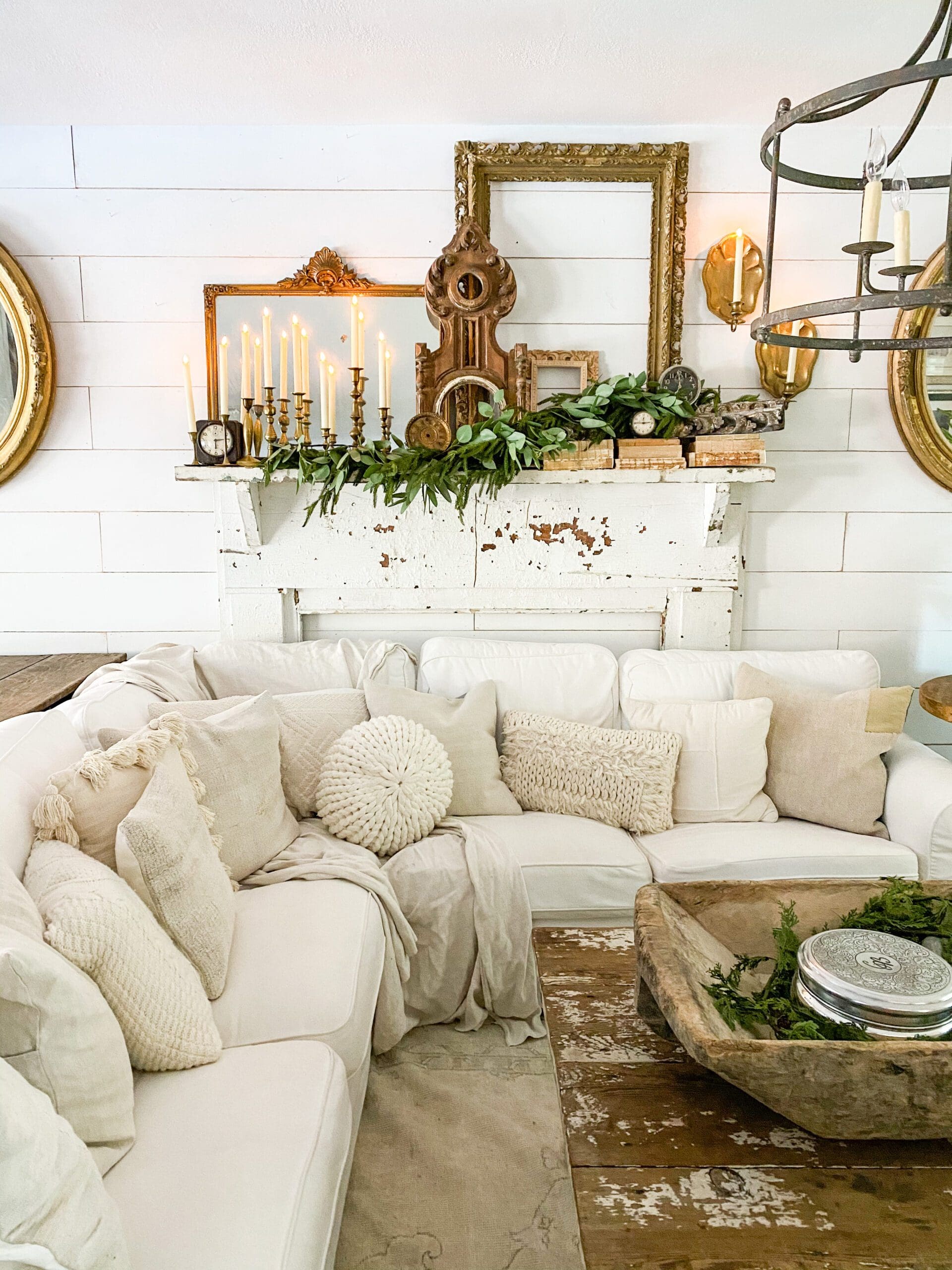 cozy white couch with a beautiful vignette and gallery wall behind it
