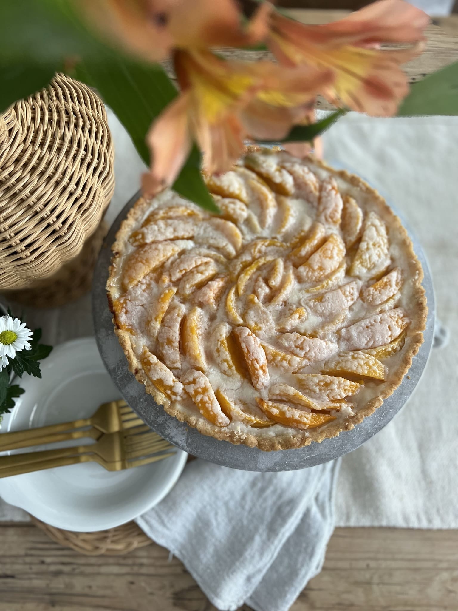 overview of a peach tart in a small vignette serving as a centerpiece