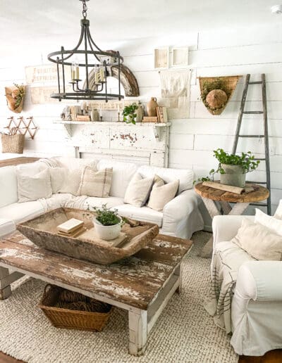 Cozy living room with white sectional and chippy white coffee table