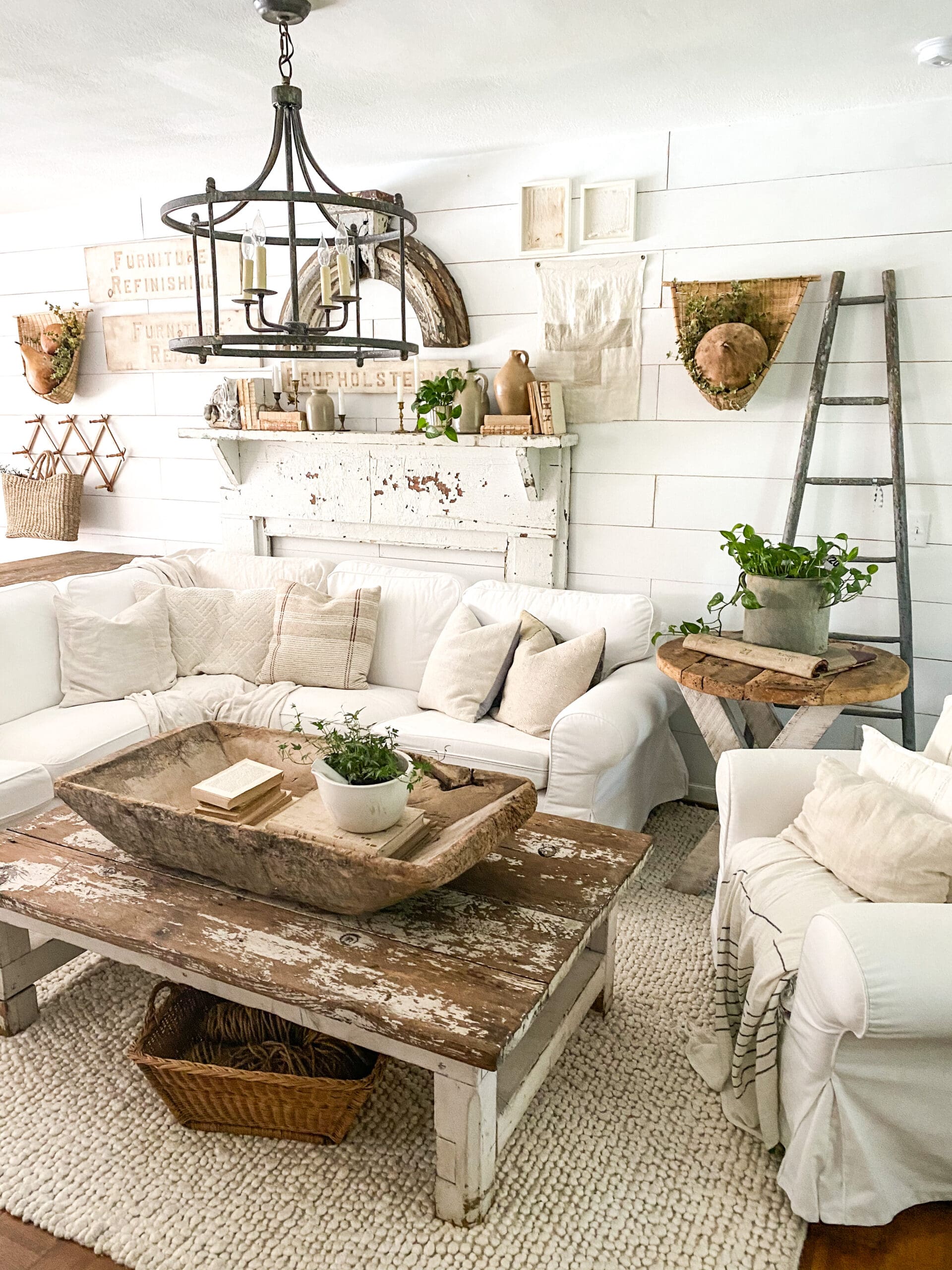 Cozy living room with white sectional and chippy white coffee table