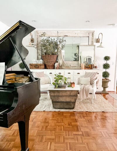 Music room with grand piano & large french basket full of trimmings from yard trees