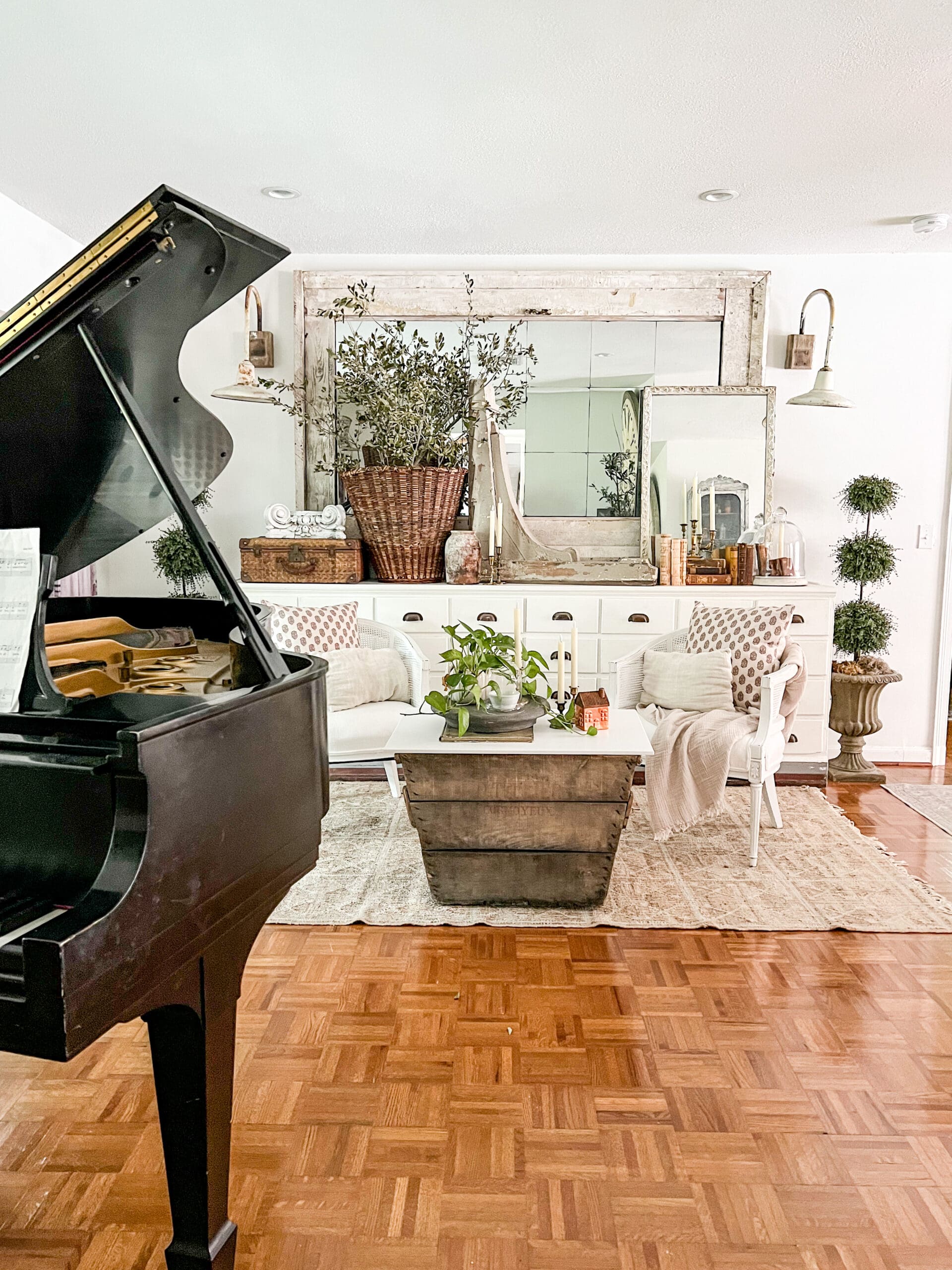Music room with grand piano & large french basket full of trimmings from yard trees