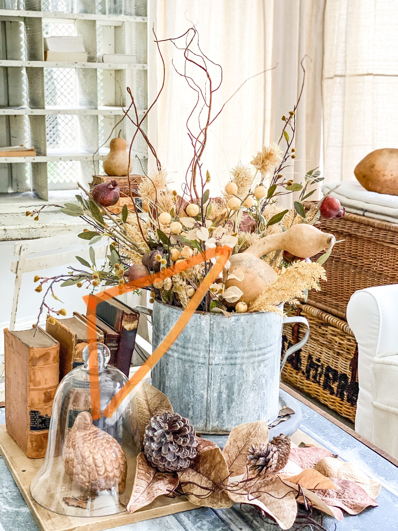 Coffee table centerpiece vignette styled for fall, displaying the typical designer's triangle as shared above