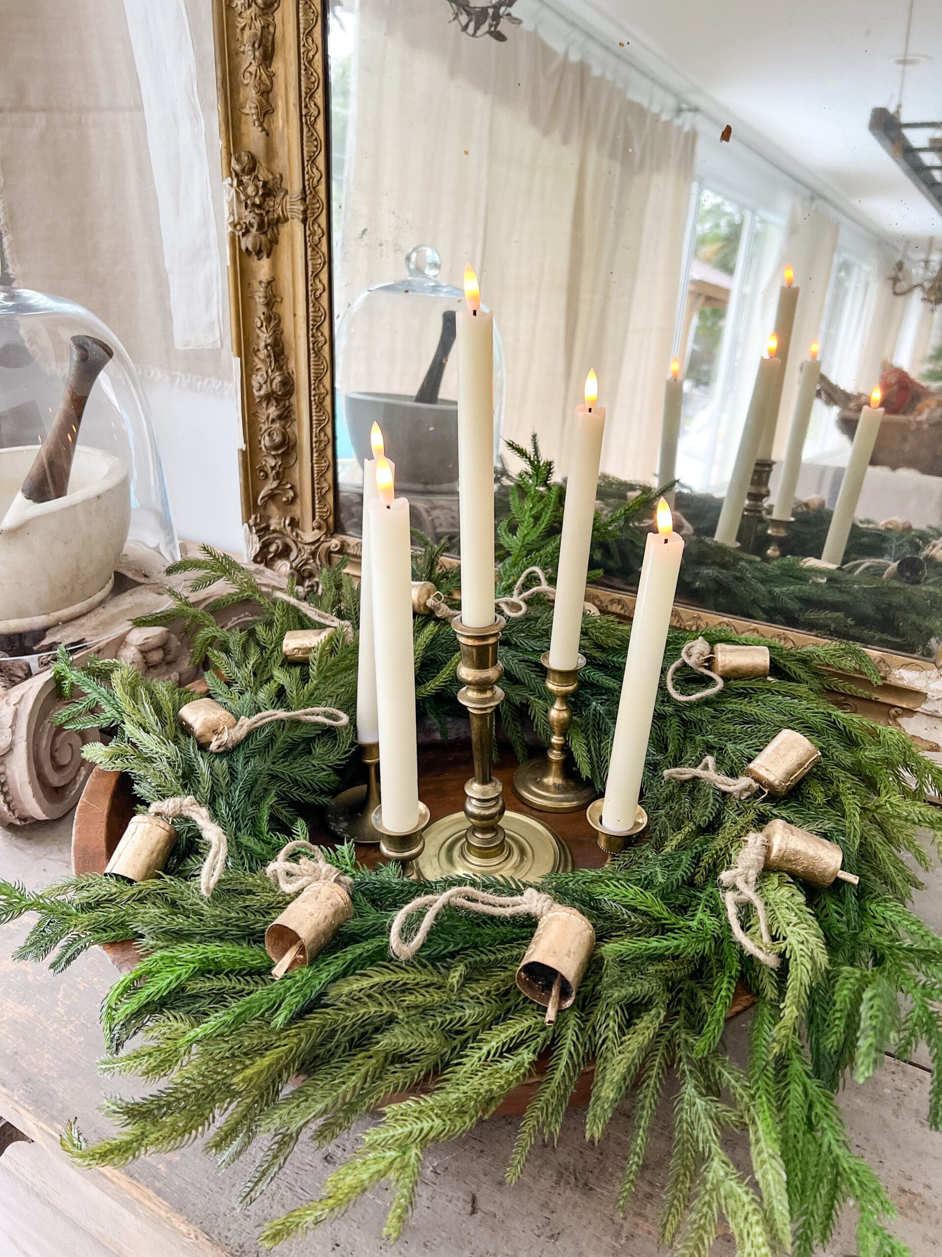 close up of advent wreath with five white candlesticks
