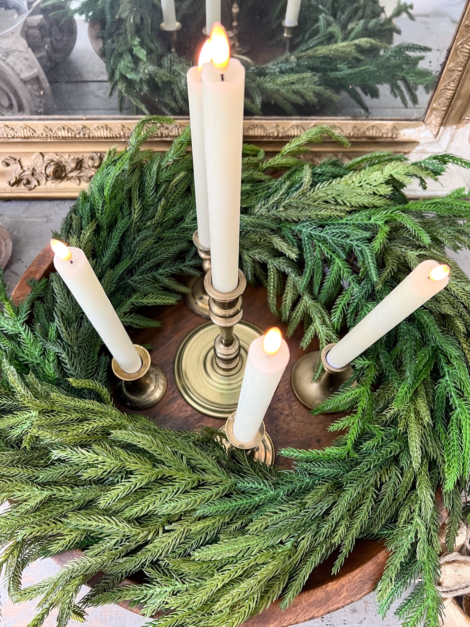 5 candles on golden candlesticks inside the wreath