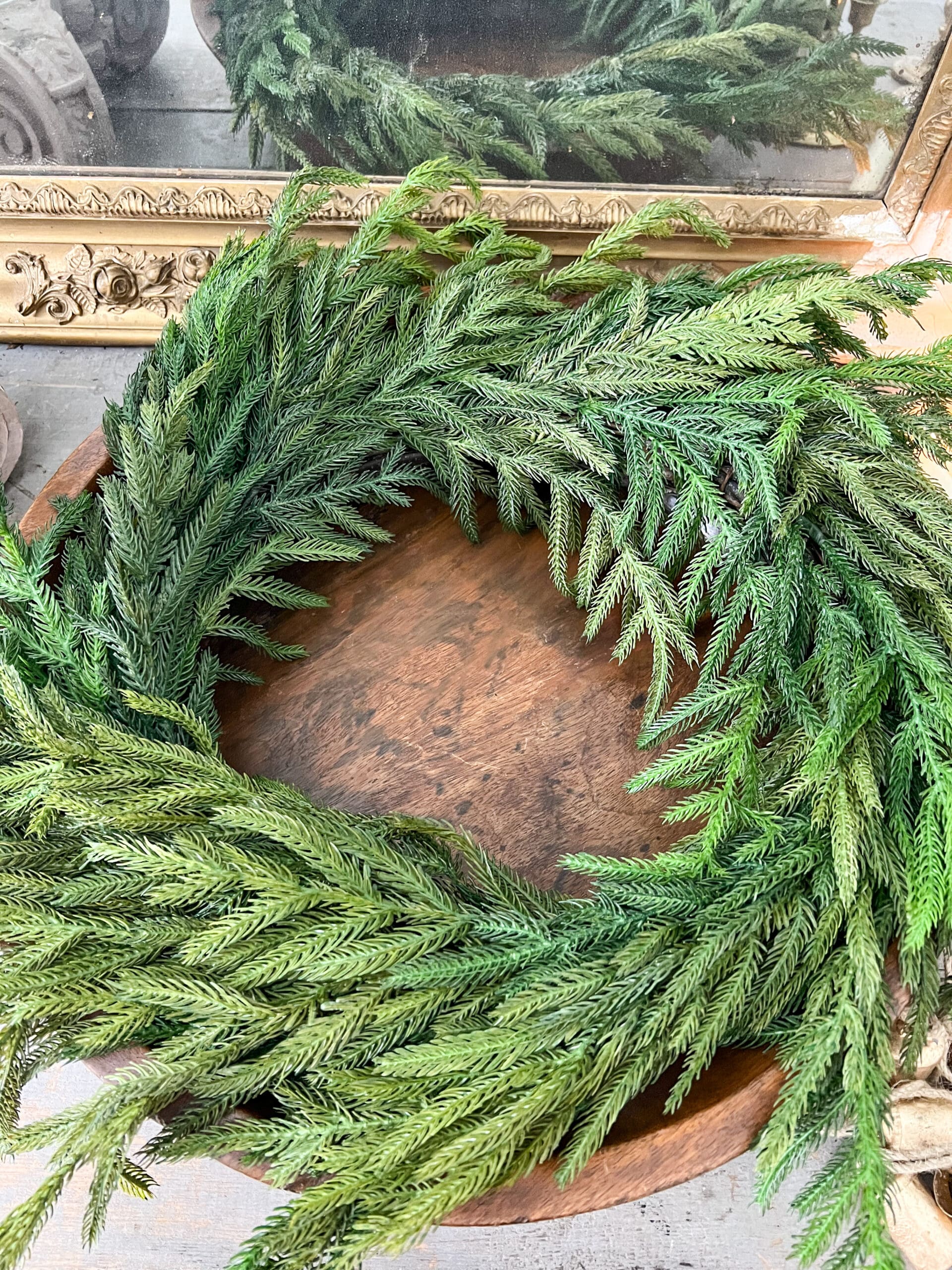 beautiful real-touch wreath inside a round wooden bowl