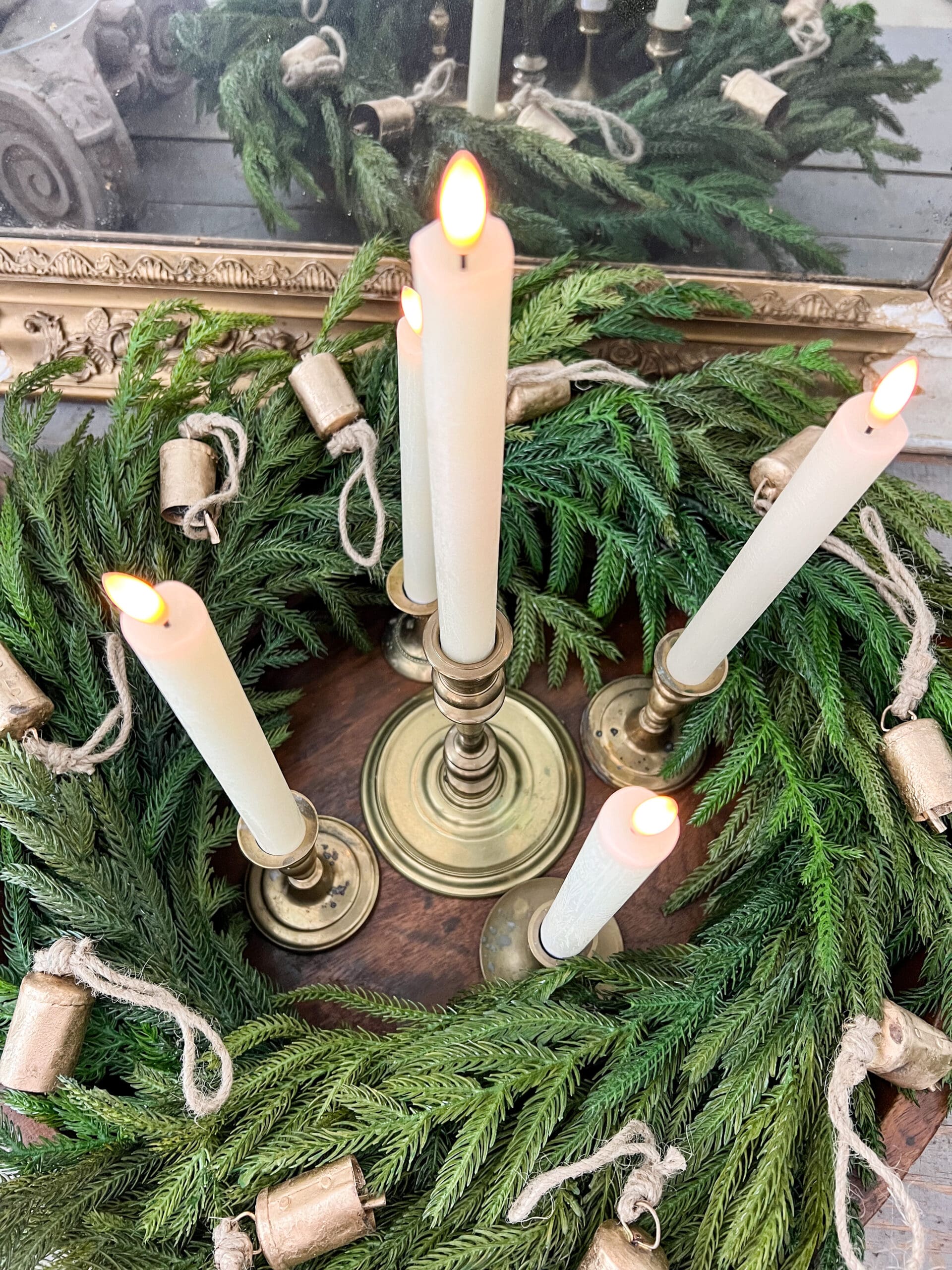 center candle of the advent wreath on a golden candlestick at the bottom of the vessel