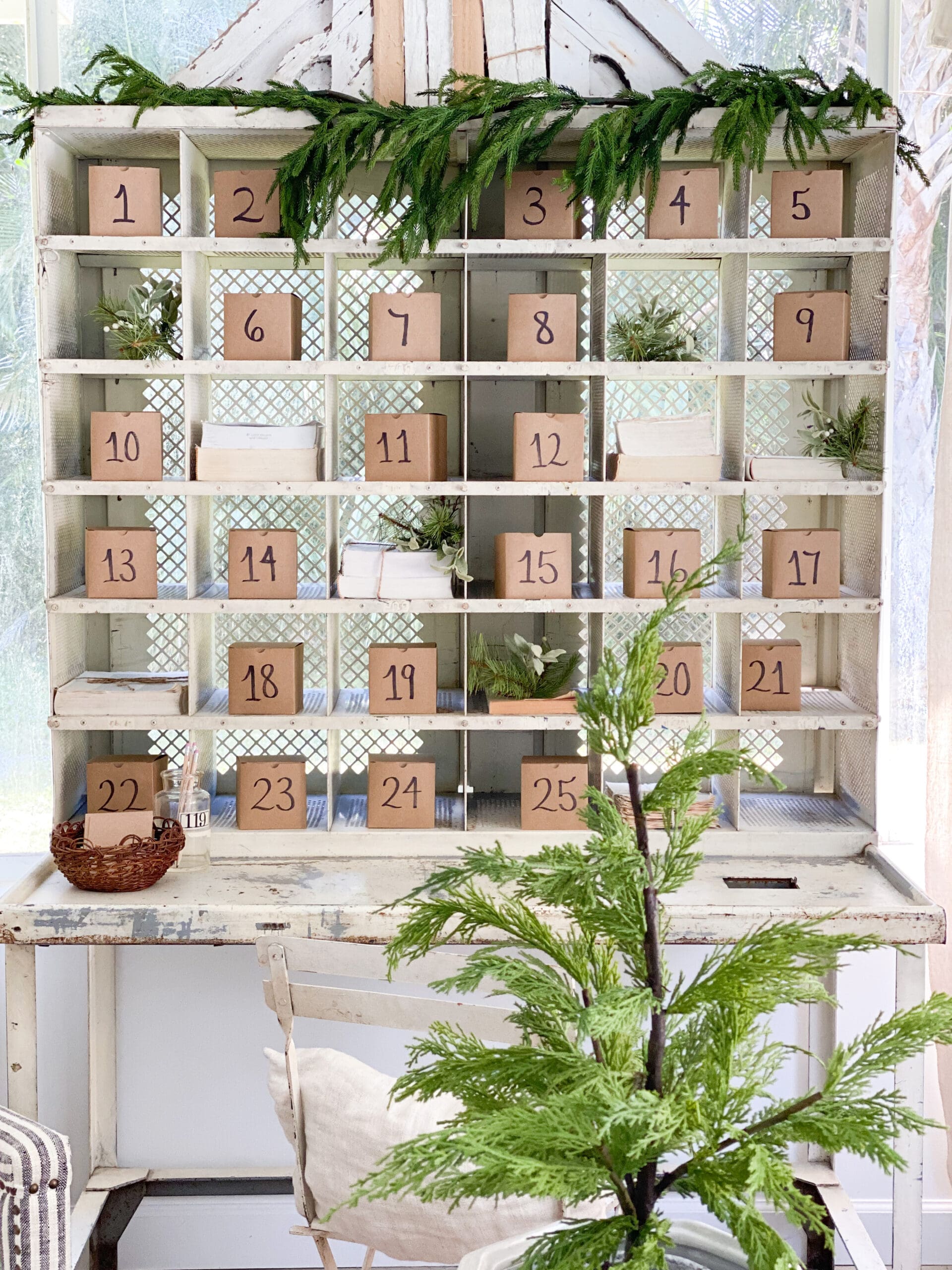 advent boxes in a white cubby with a Christmas garland