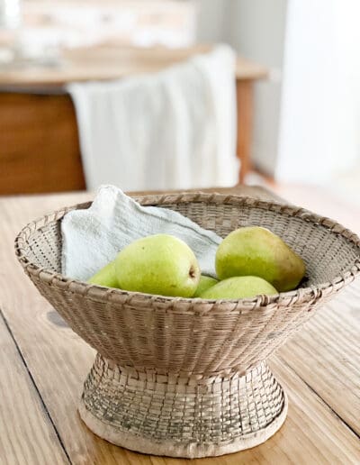Wicker basket with fresh greeen pears sit on the kitchen island ready for hungry after-school appetites.