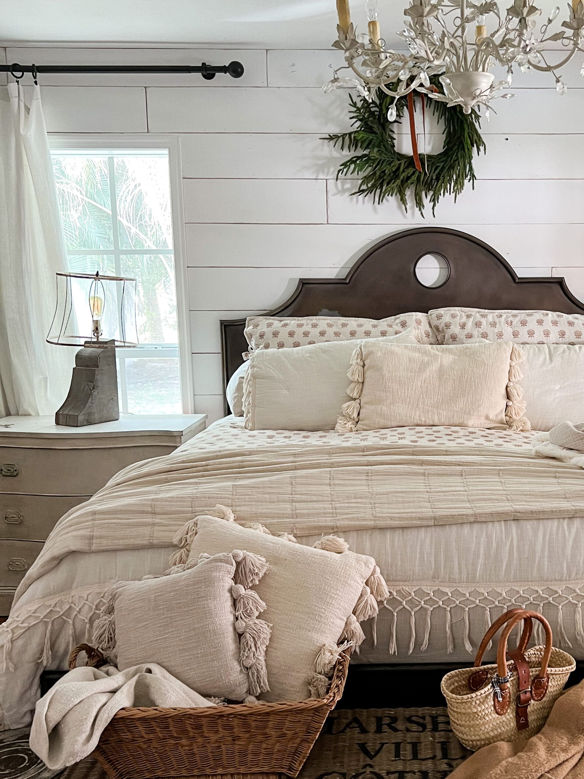 image of a beautiful white nightstand next to a cozy neutral bed