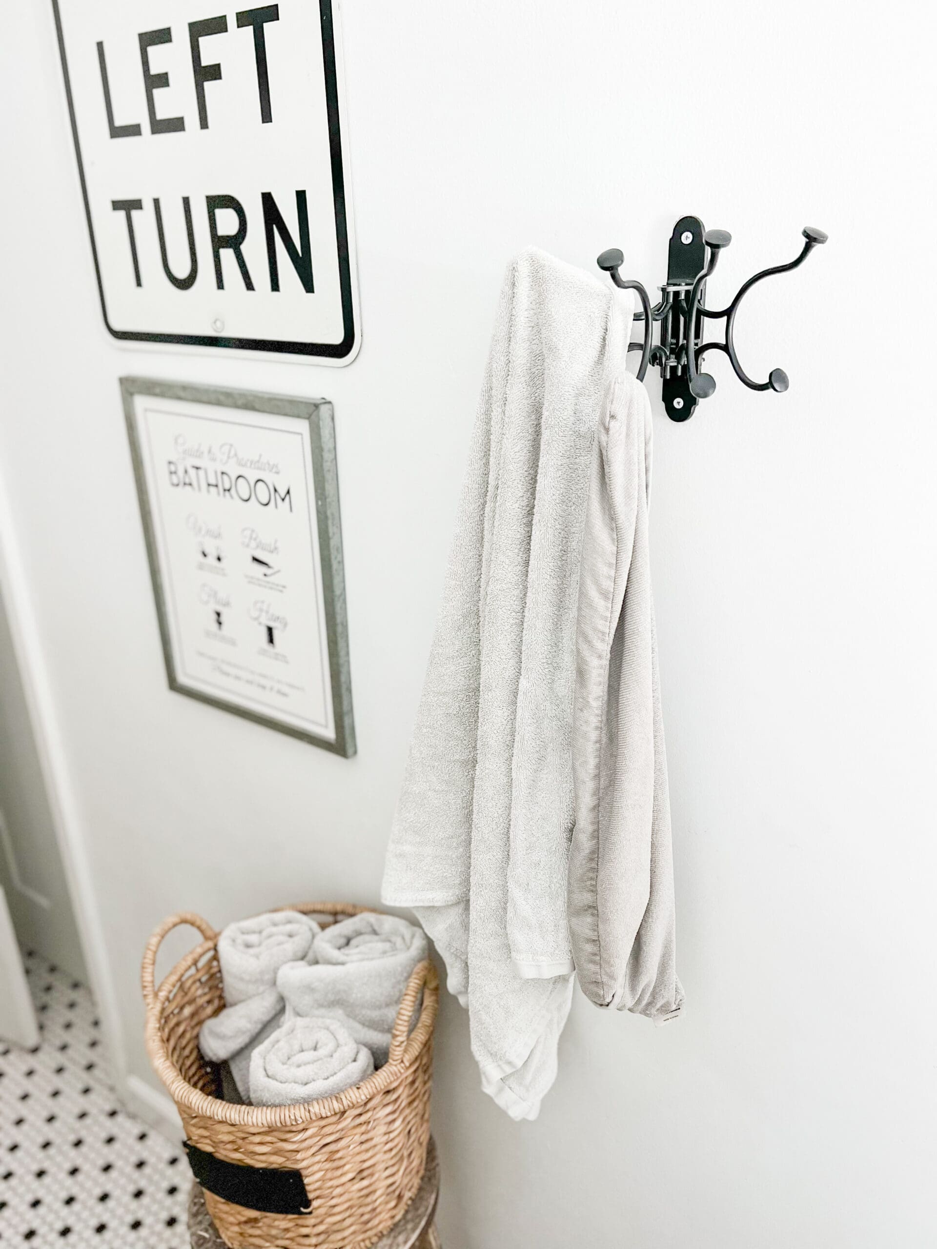 Towel hook from Pottery Barn easily holds 4-8 towels at a time. The black metal matches its surrounding perfectly.