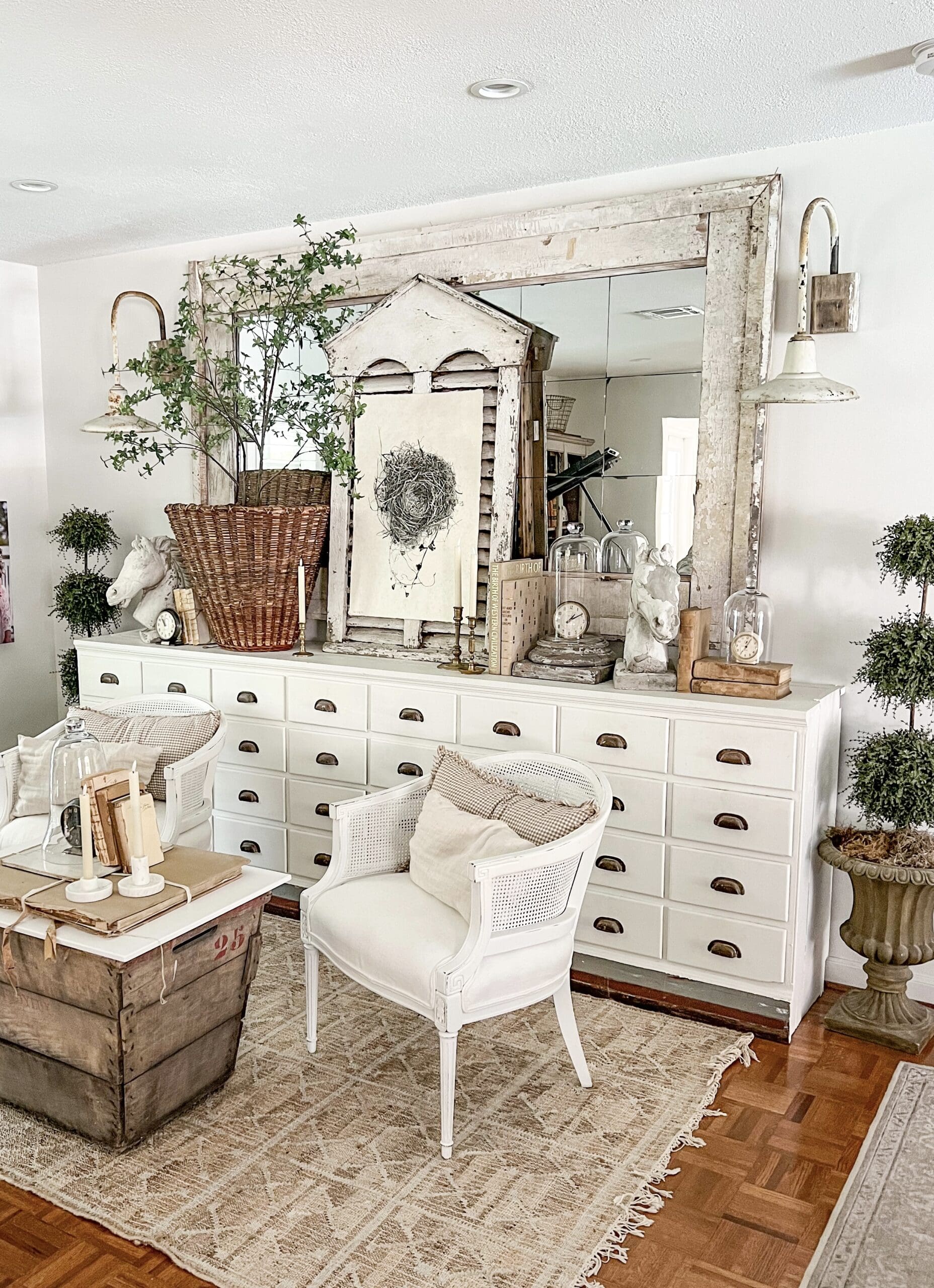 music room apothecary with a large tree and mirror styled with other spring decor