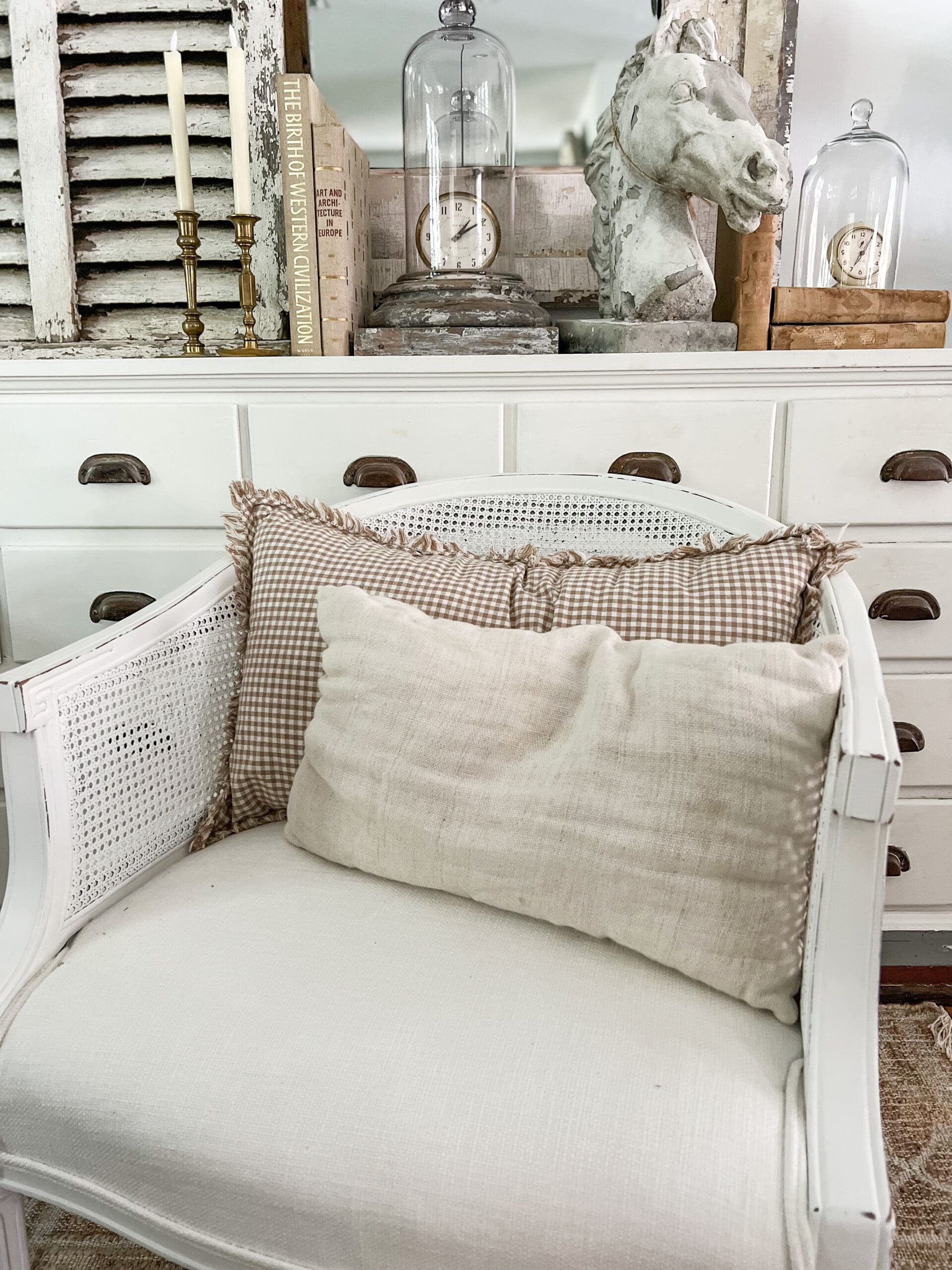 rectangular checked pillows on white chairs