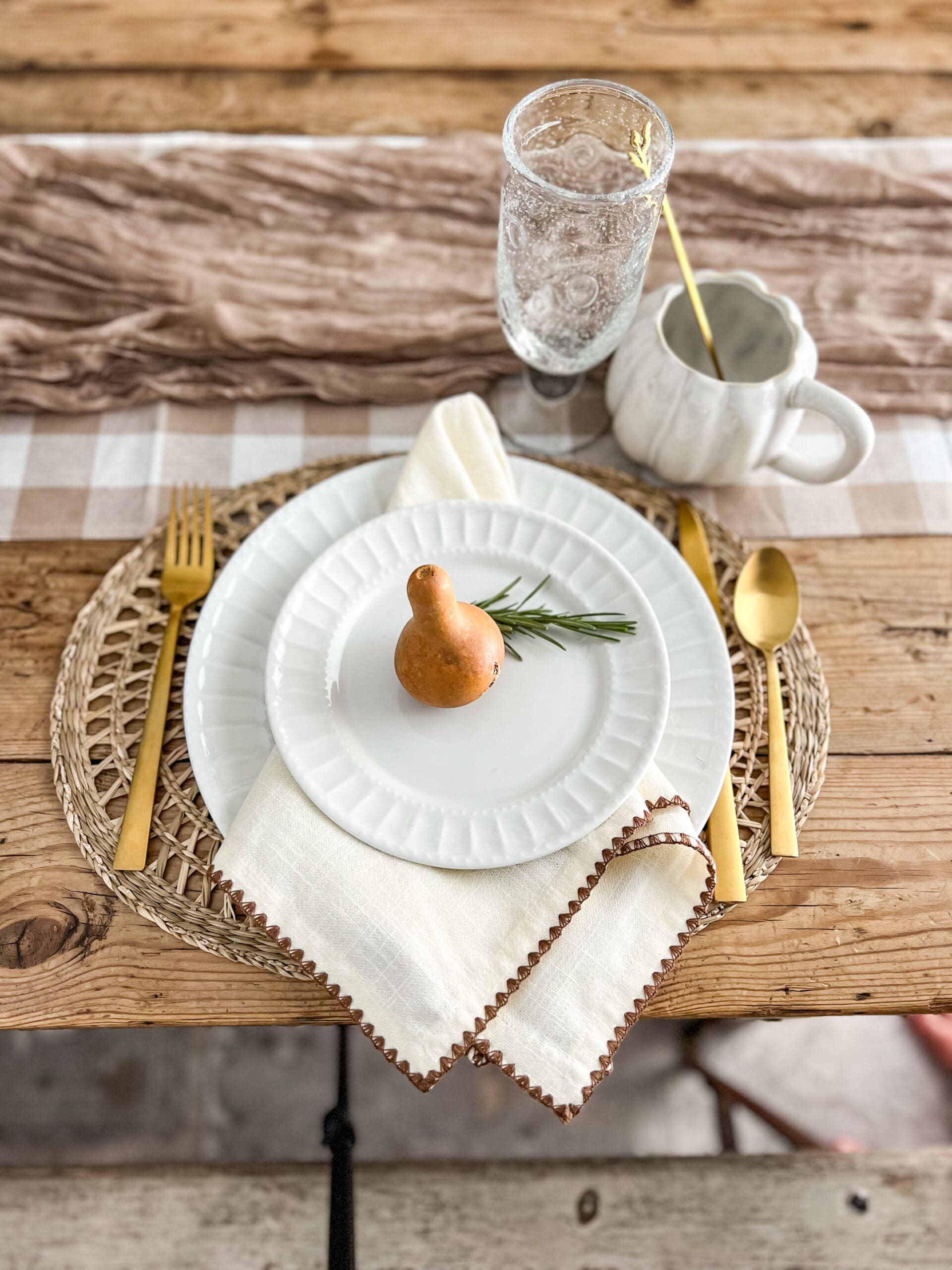 small gourd and piece of rosemary on a white plate