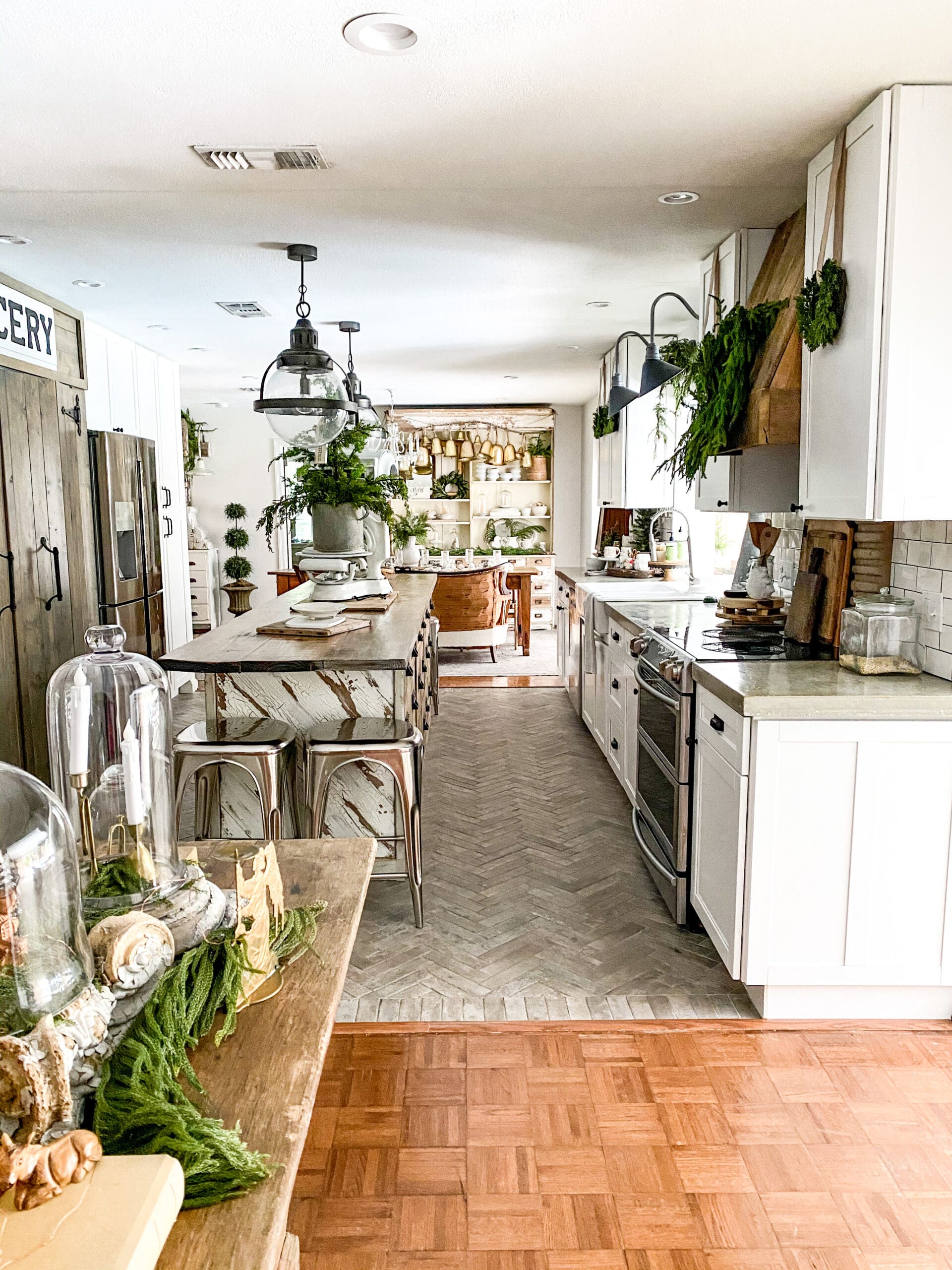 long view of a cozy kitchen styled with Christmas greenery