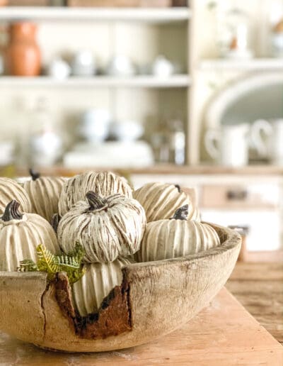 Small white pumpkins in a wooden dough bowl