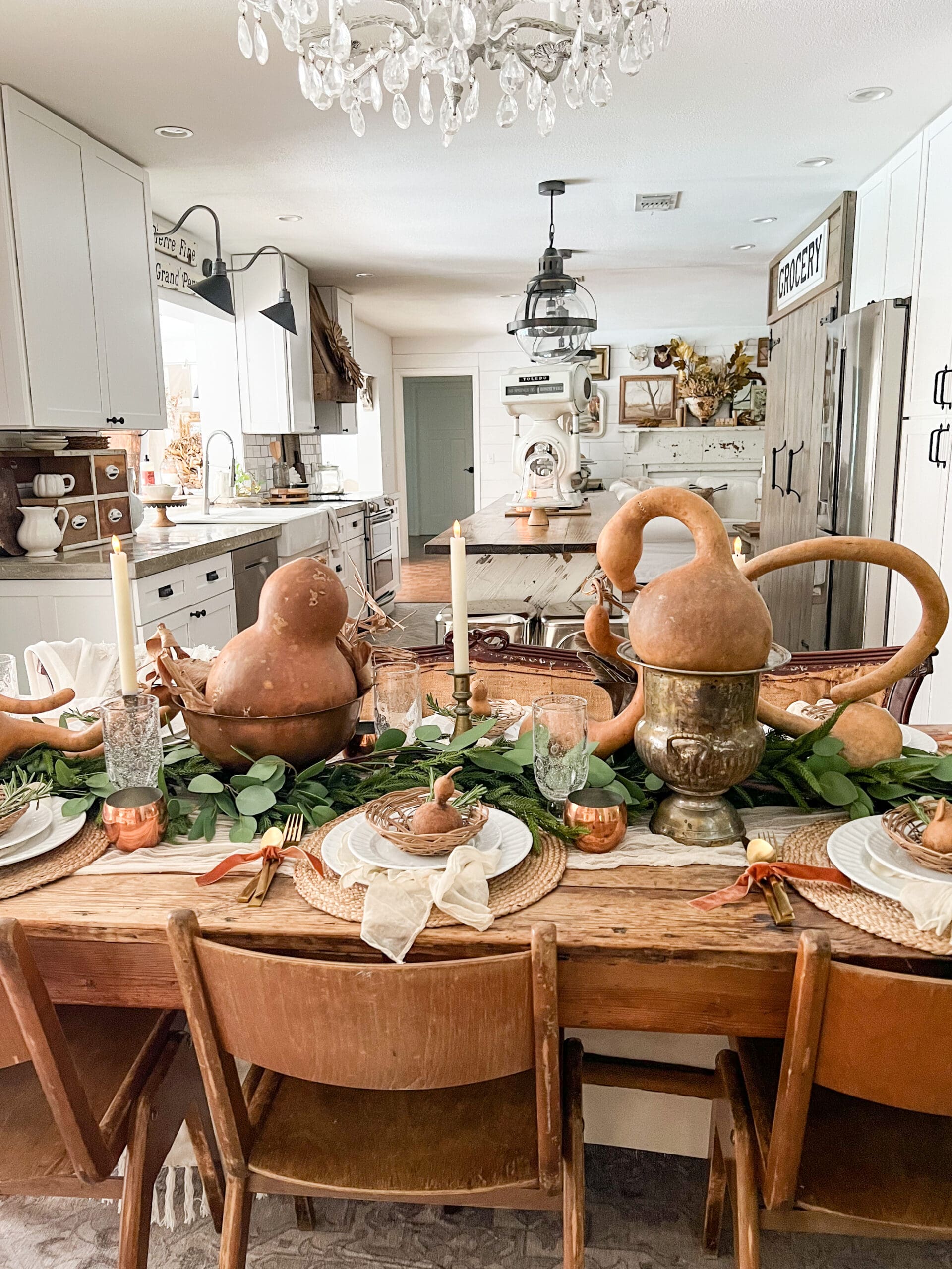 view of dining table styled with gourds and greenery