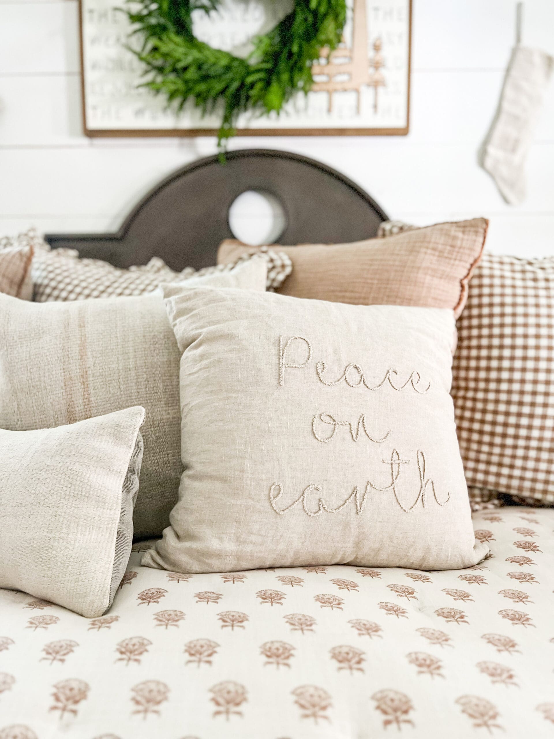 neutral pillow with the words "peace on earth" on it