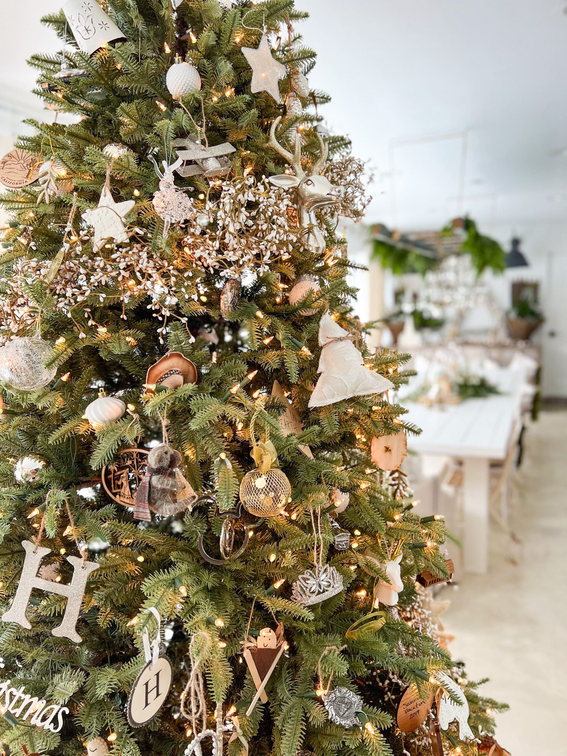 large Christmas tree with lots of different family-related ornaments