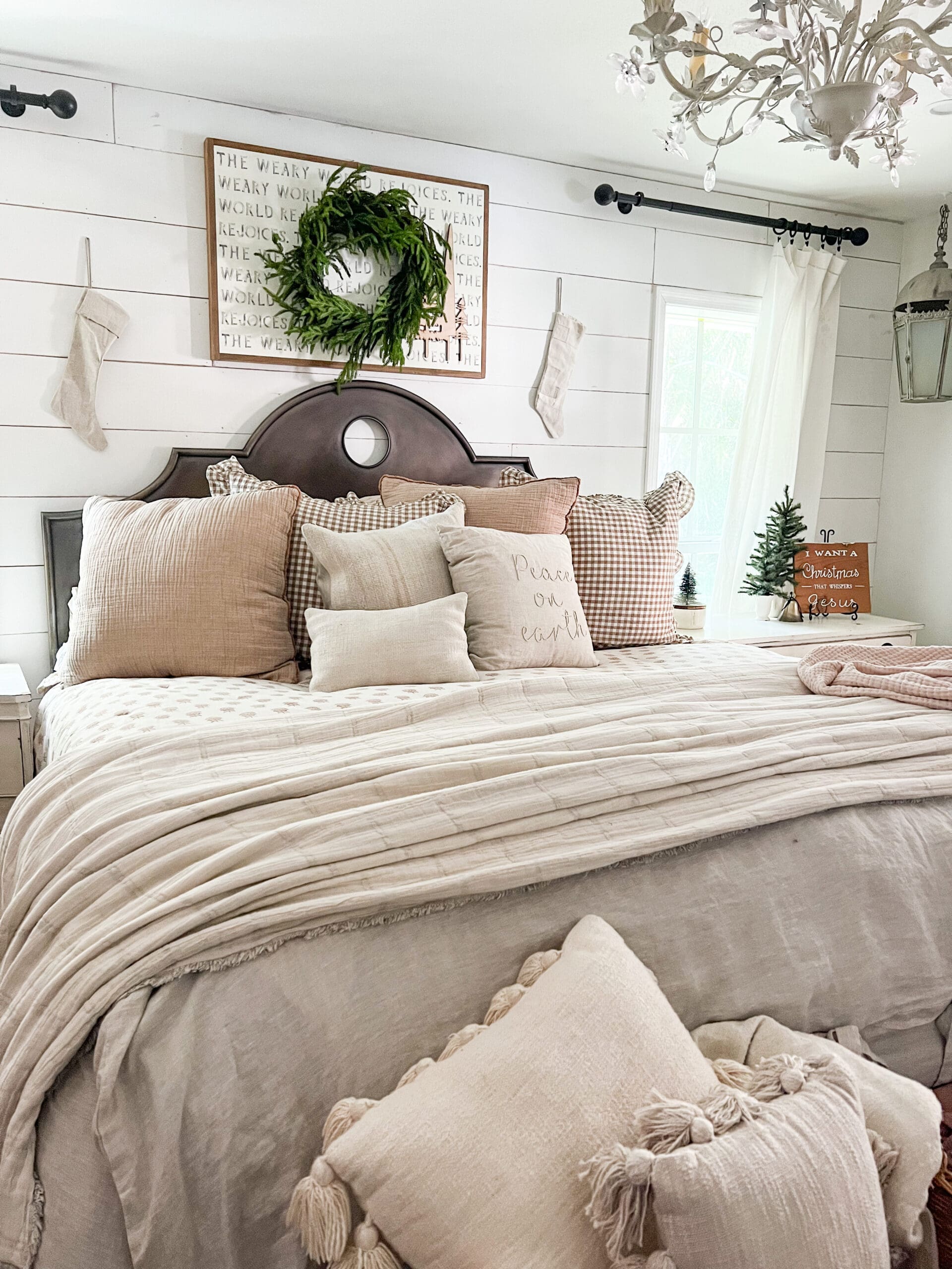 image of a neutral bed and nightstands styled for Christmas