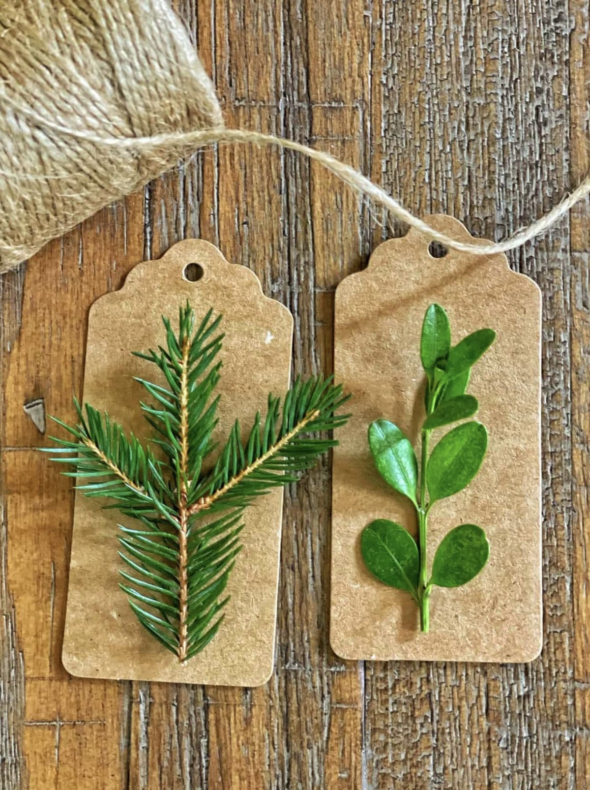 brown gift tag with small sprig of greenery attached to it