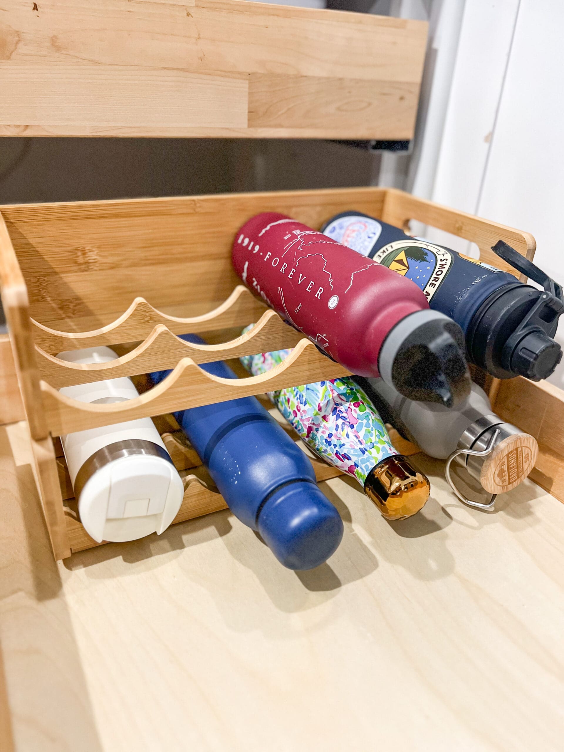 view of a bamboo water bottle holder in a drawer