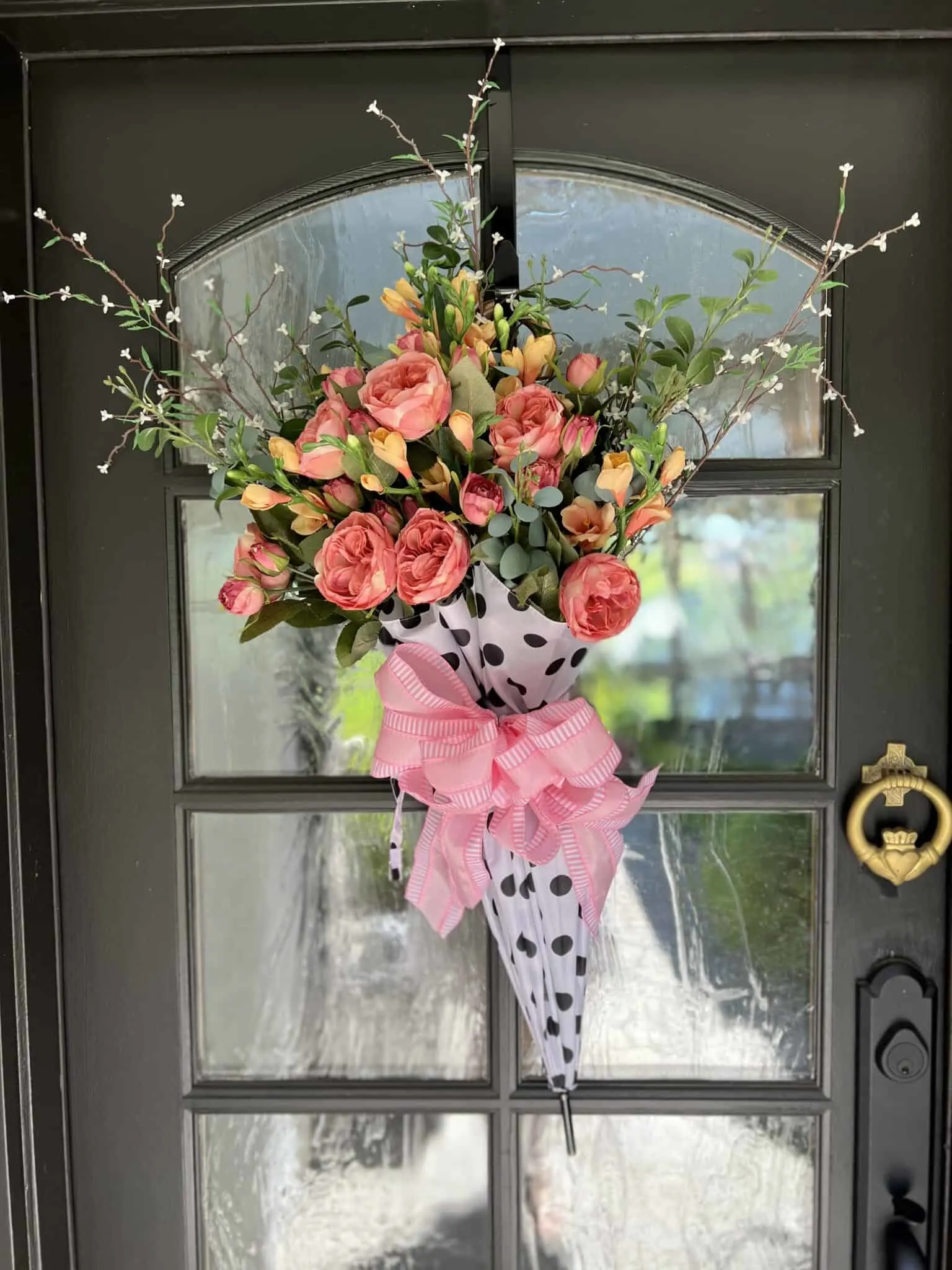 gorgeous arrangement of flowers hanging on the front door