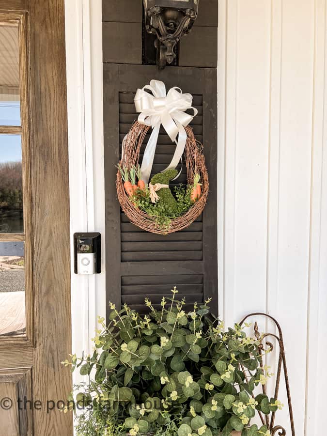 beautiful small spring wreath hanging on a shutter