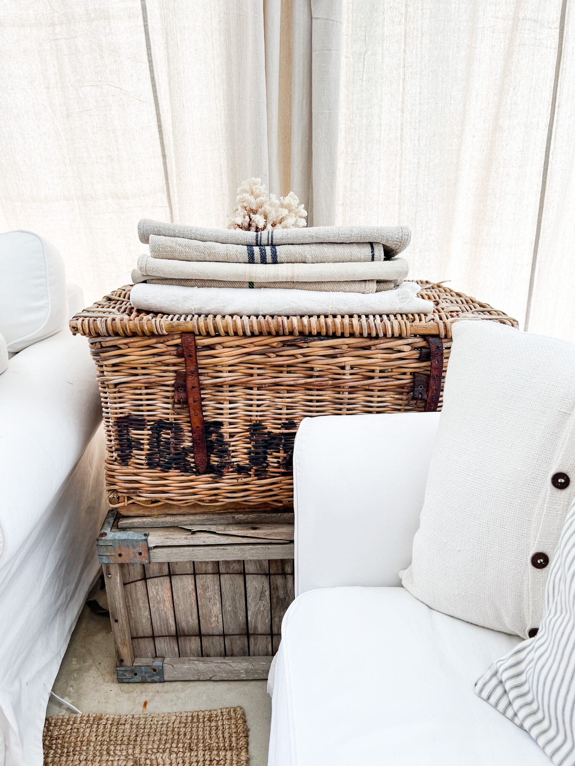 large crate with a large basket stacked on top to use as a side table