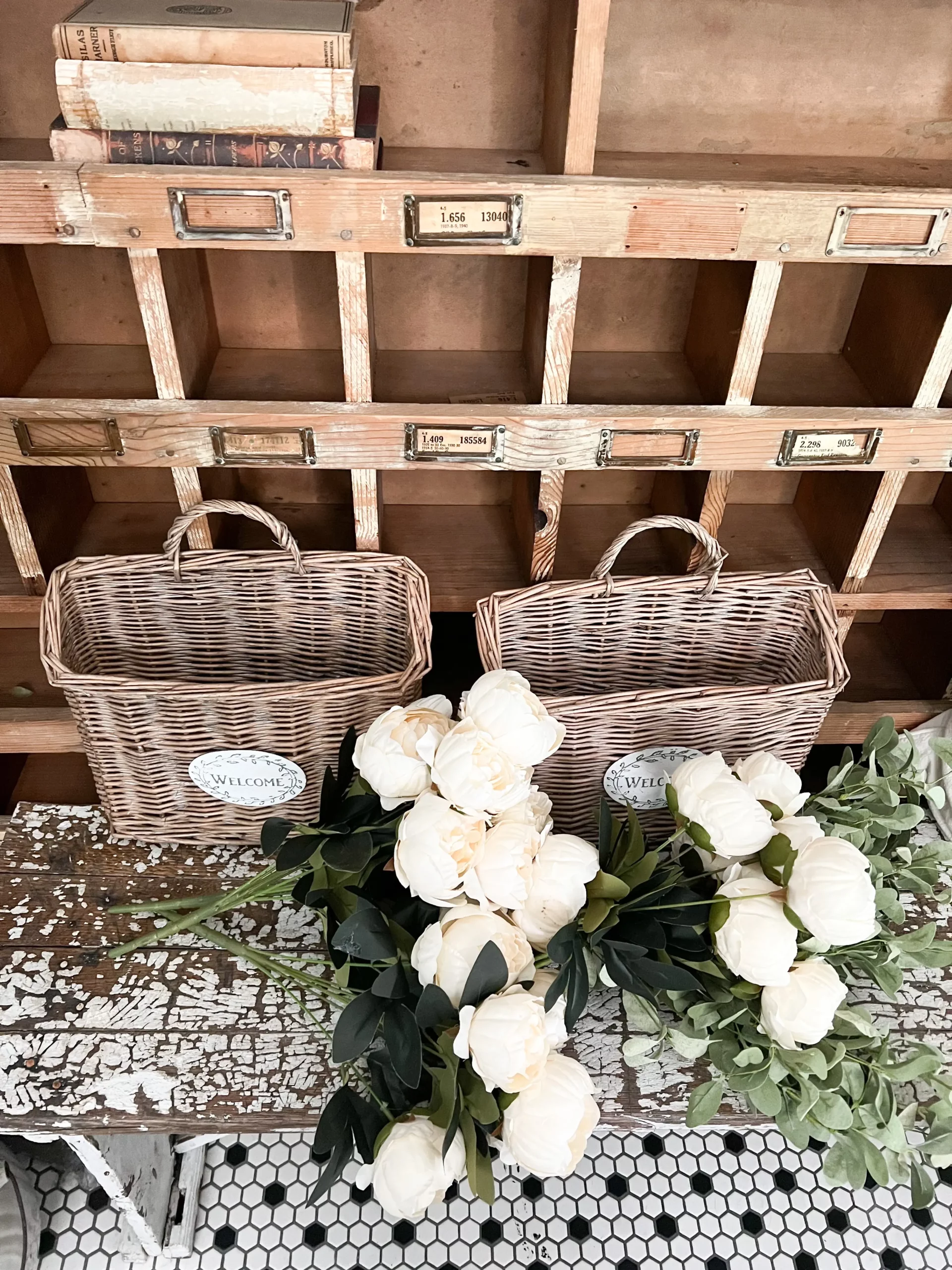 rectangular baskets with faux flowers ready to be styled on a front porch