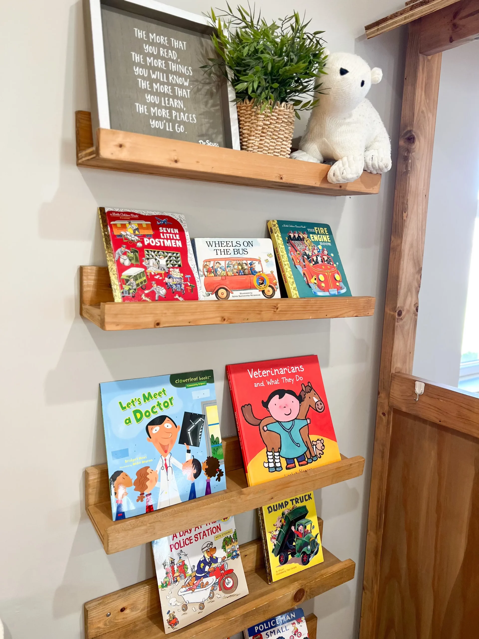adorable wooden shelves with various children's books and other kids' decor