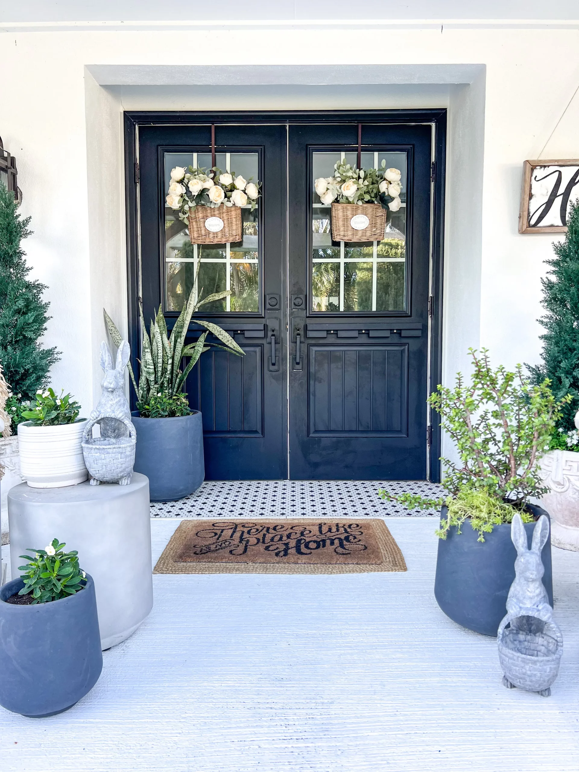 beautiful spring porch with big black doors and beautiful spring flowers