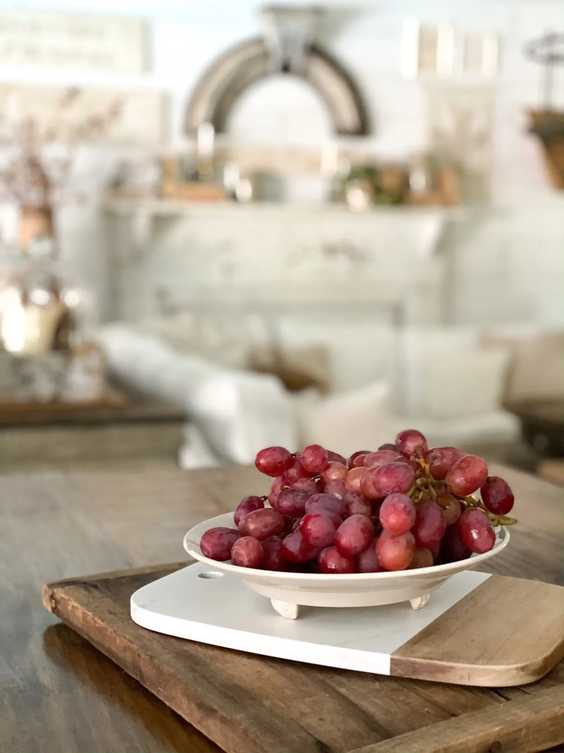 fresh red grapes in an ironstone dish on a kitchen island