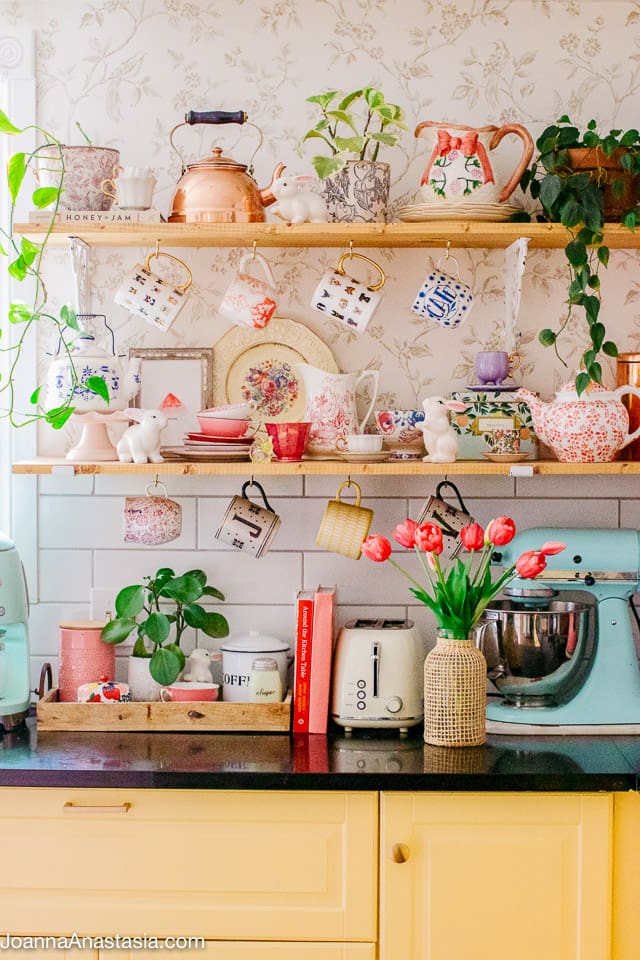shelves with different cups and mugs arranged in a kitchen