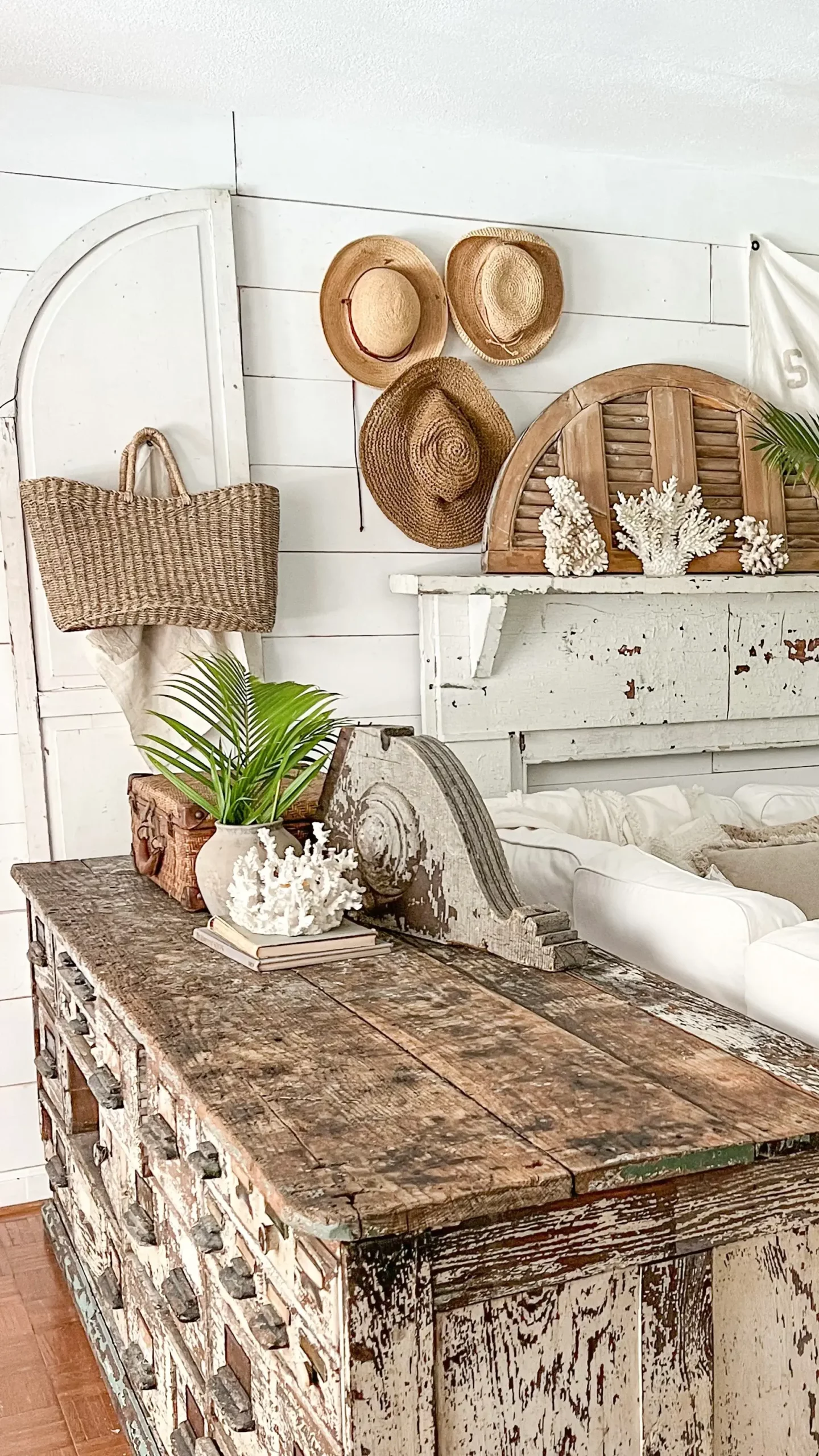 large wooden arched piece on a white mantel as part of summer decor in the living room