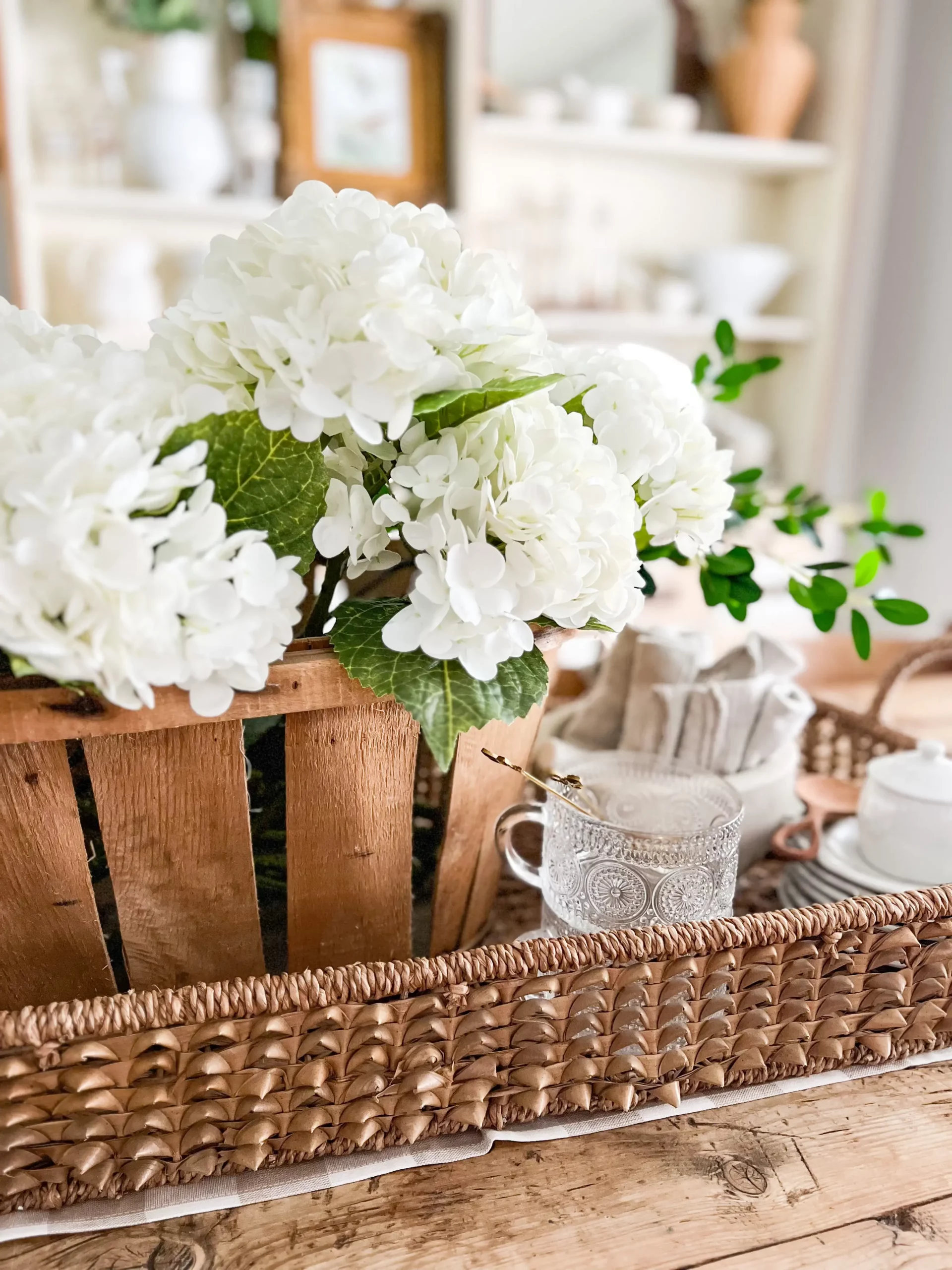 faux white hydrangeas in a wooden flower box as a centerpiece for the table