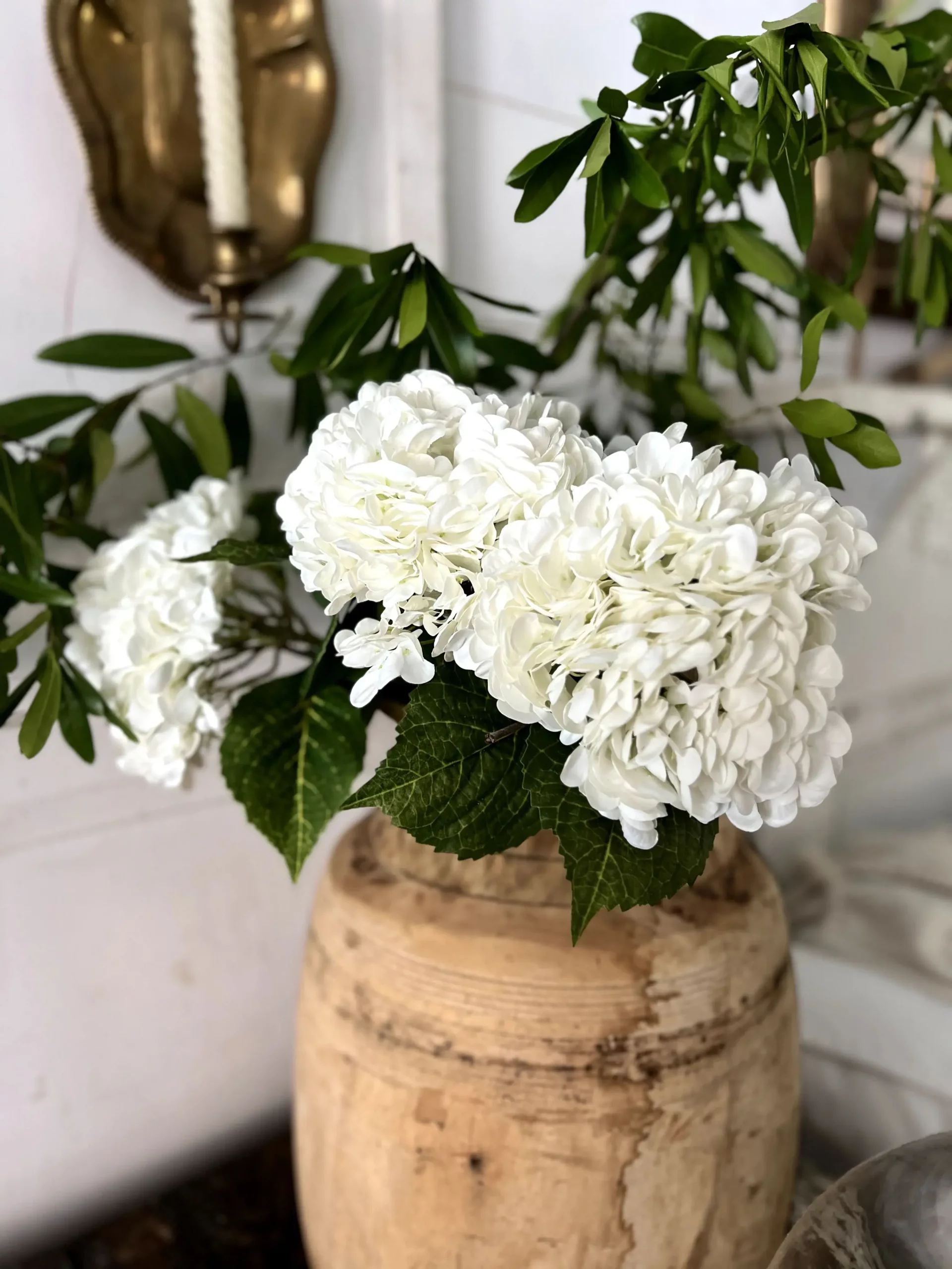 hydrangeas in a wooden vase with faux greenery