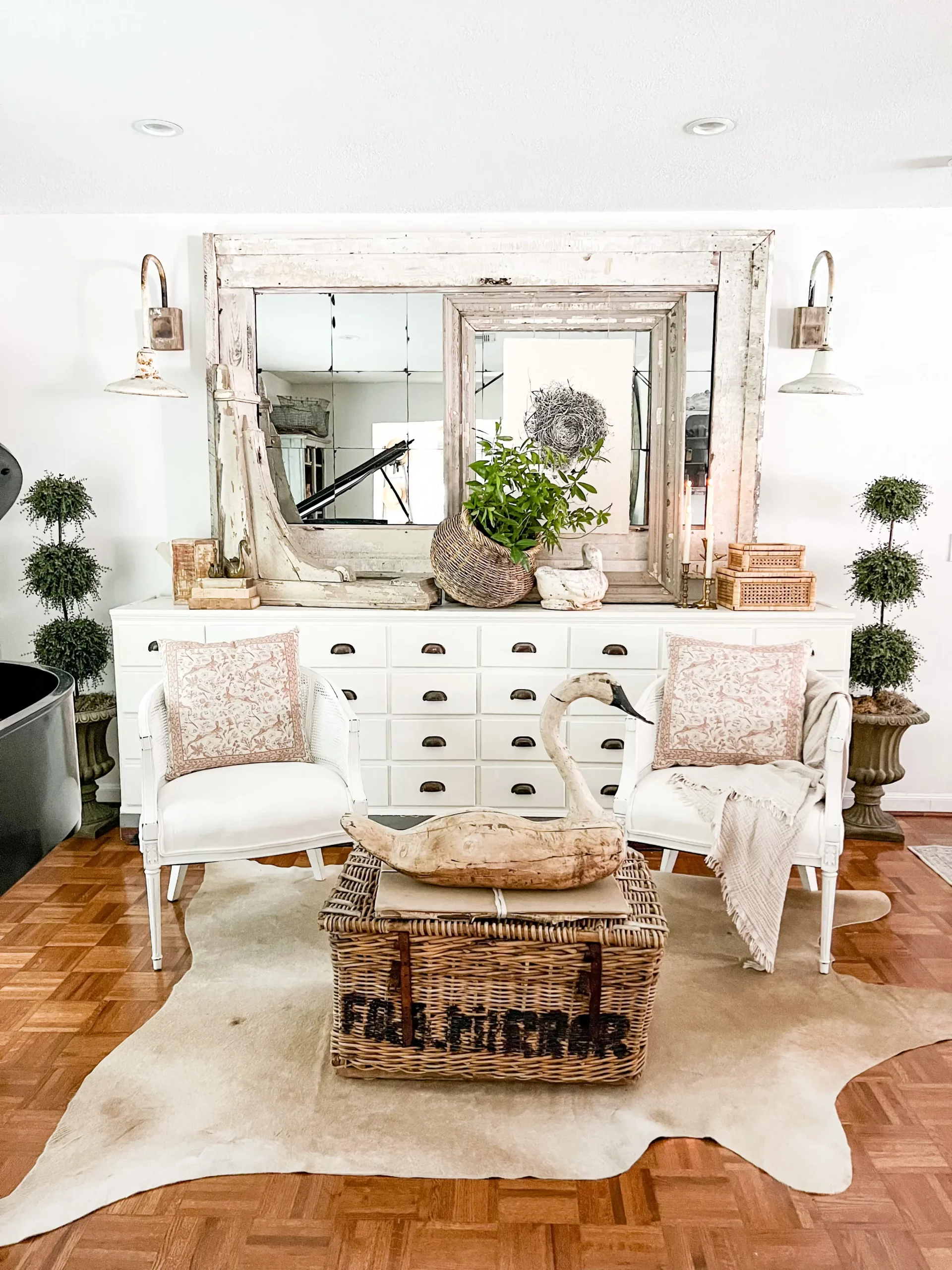beautiful vintage sconces on either side of a large mirror