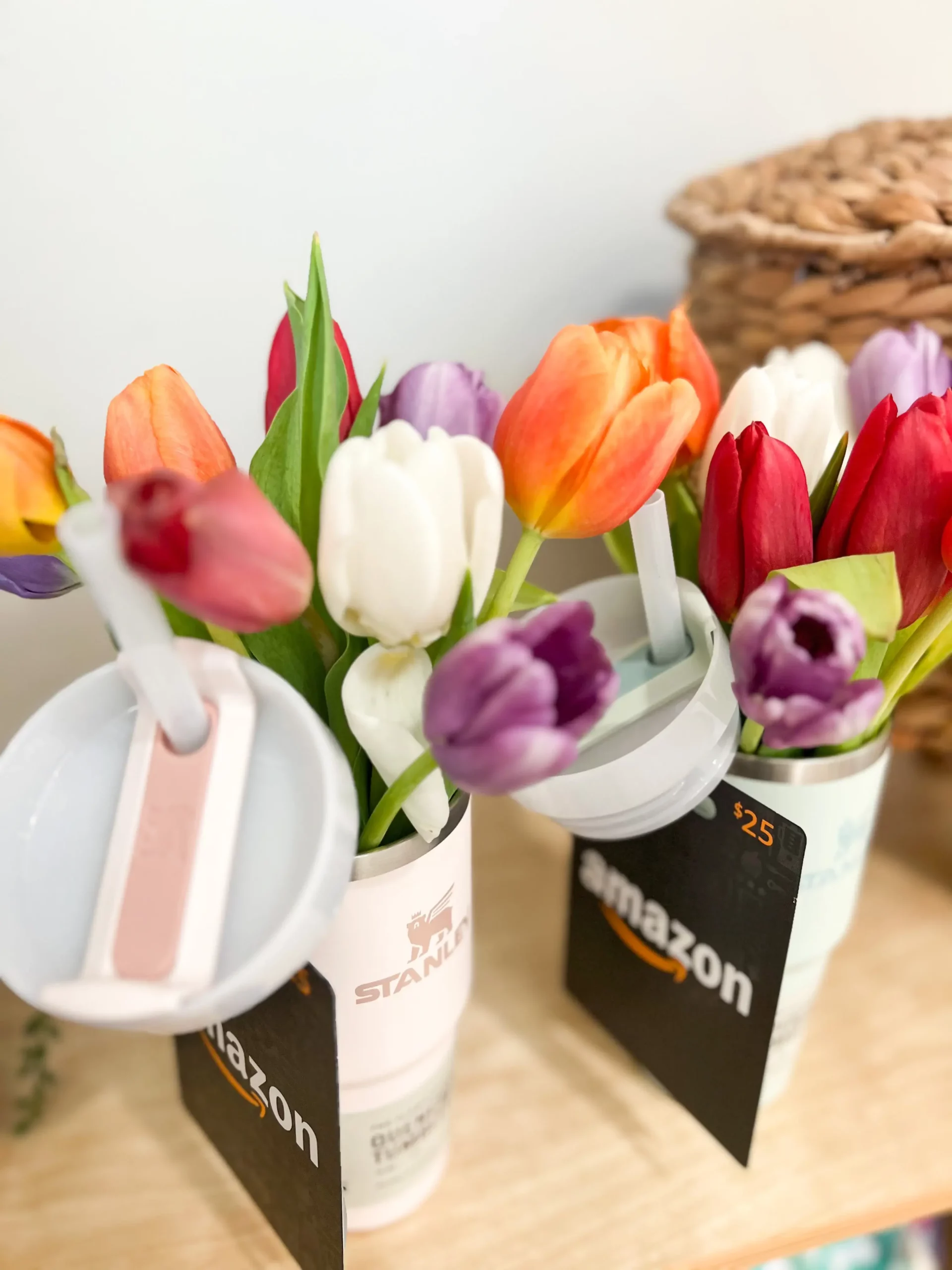 teacher appreciation gifts with an Amazon gift card tied to a small Stanley cup filled with faux tulips