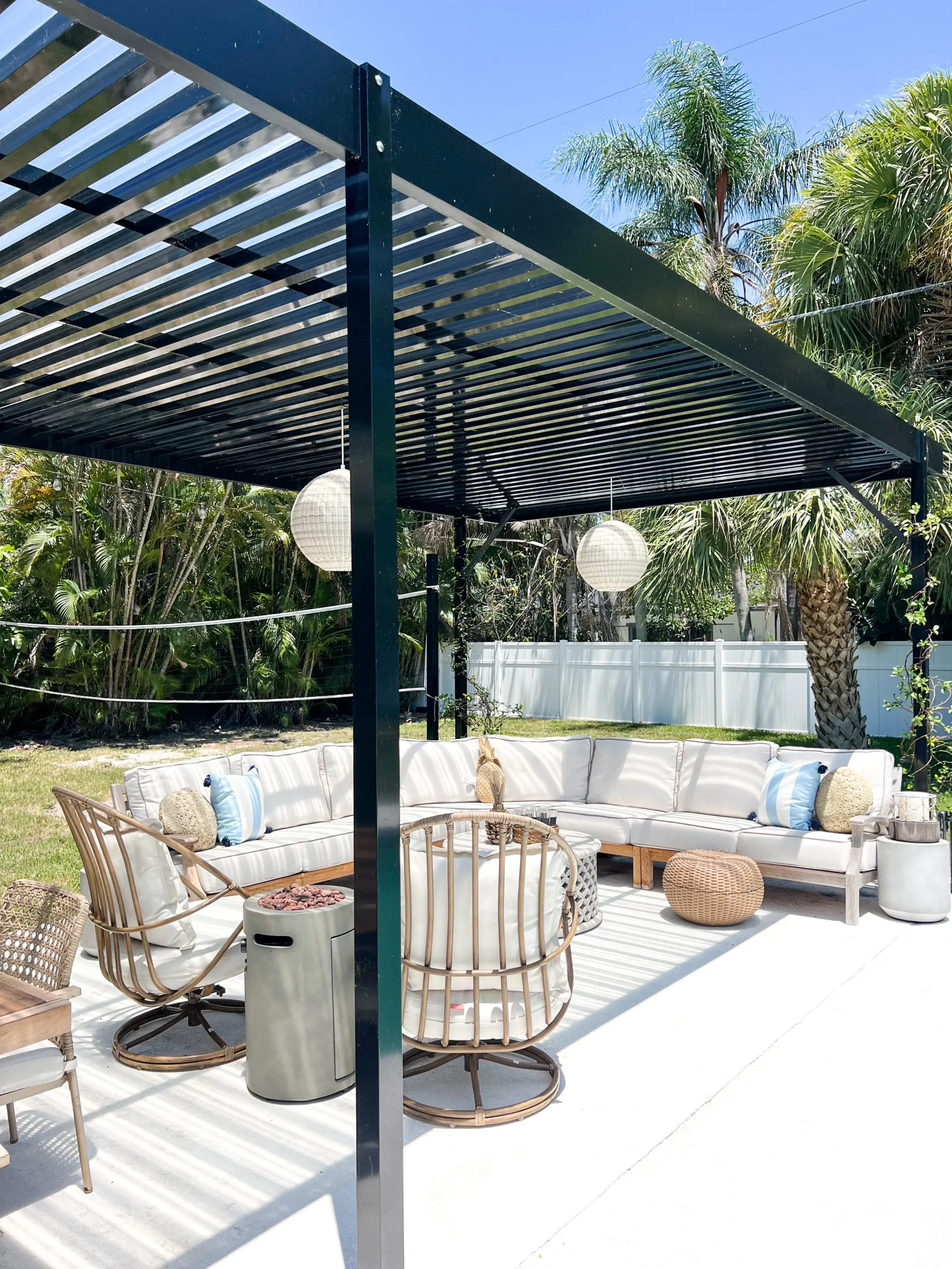 outdoor sectional with swivel chairs, all with rattan and blue and white pillow